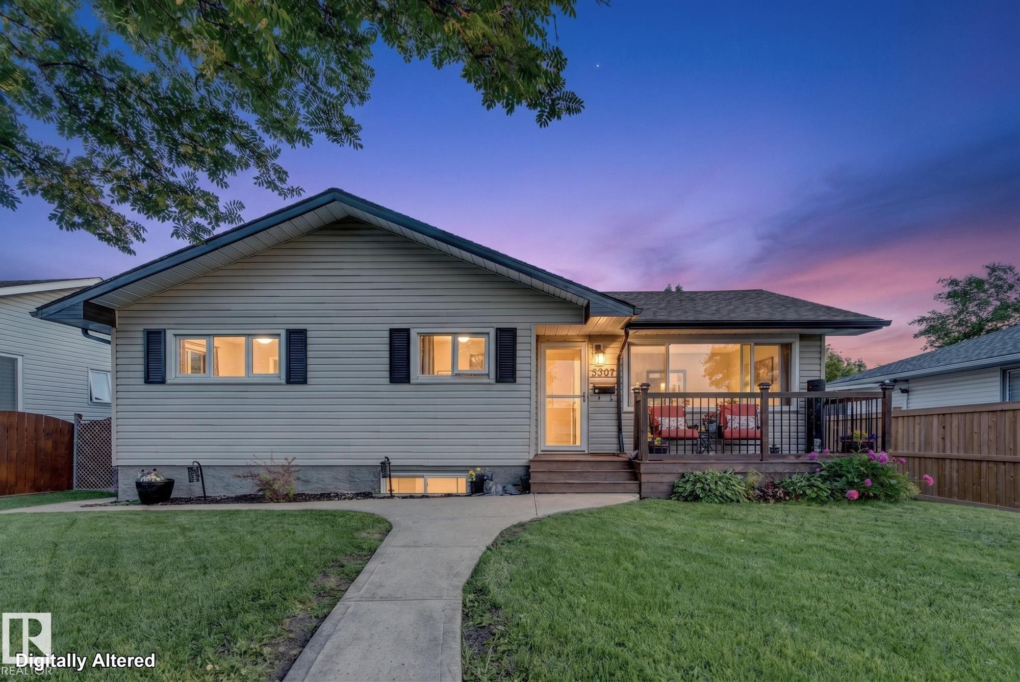 Ranch-style residence featuring light-toned siding, a dark pitched roof, and a front deck with dark railings - 5307 104 Avenue Nw, Edmonton, AB - Outdoor With Deck Patio Veranda