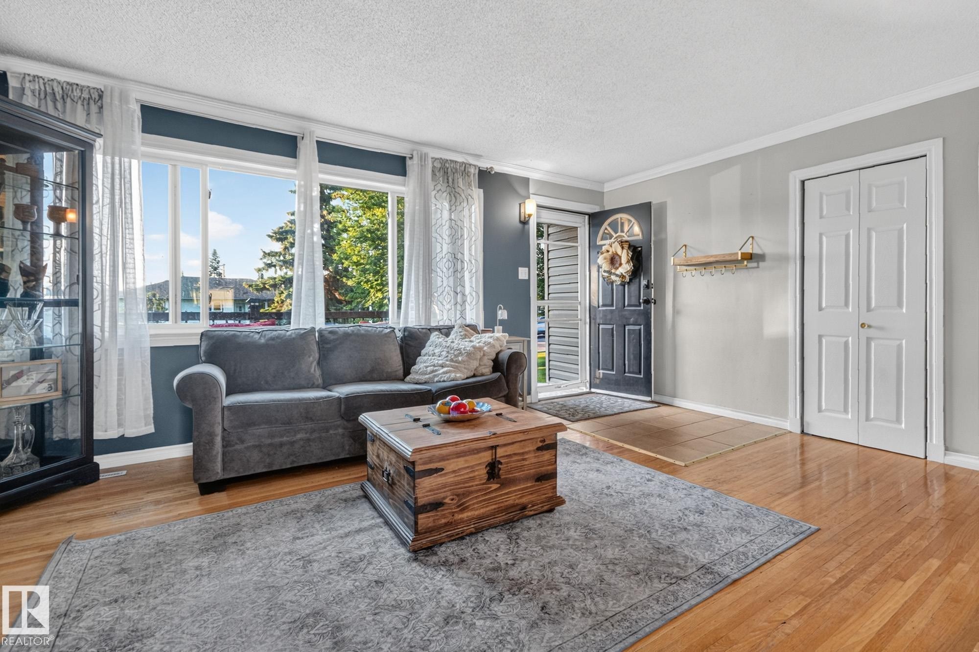 Hardwood flooring extending throughout the space - 5307 104 Avenue Nw, Edmonton, AB - Indoor Photo Showing Living Room With Fireplace
