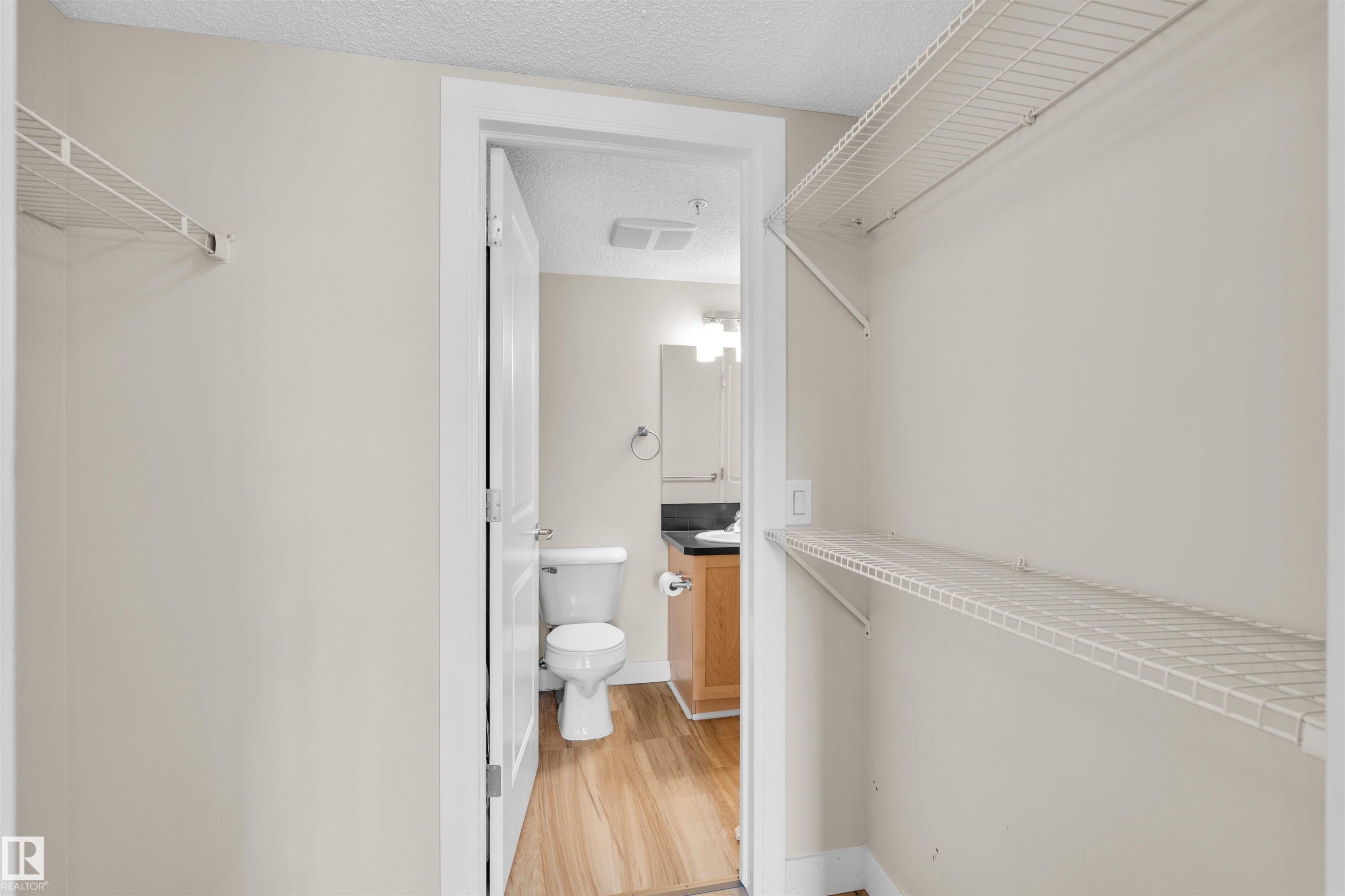 Walk-in closet with integrated wire shelving - #317 3719 Whitelaw Ln Nw, Edmonton, AB - Indoor Photo Showing Bathroom