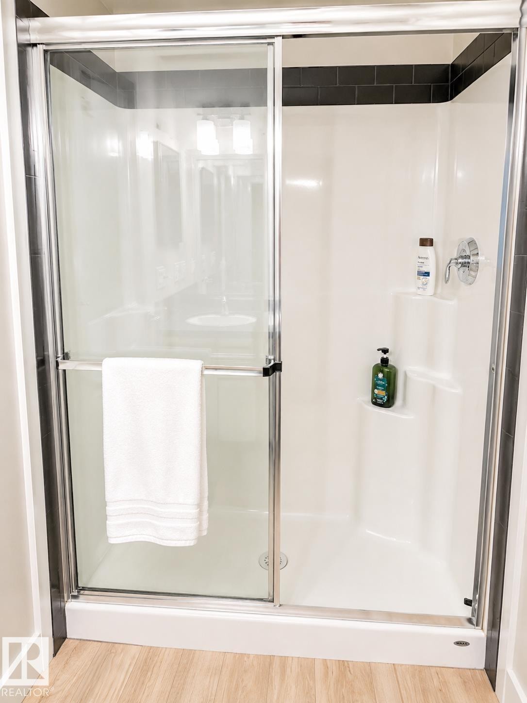 White shower stall with sliding glass doors and a chrome handle - #317 3719 Whitelaw Ln Nw, Edmonton, AB - Indoor Photo Showing Bathroom