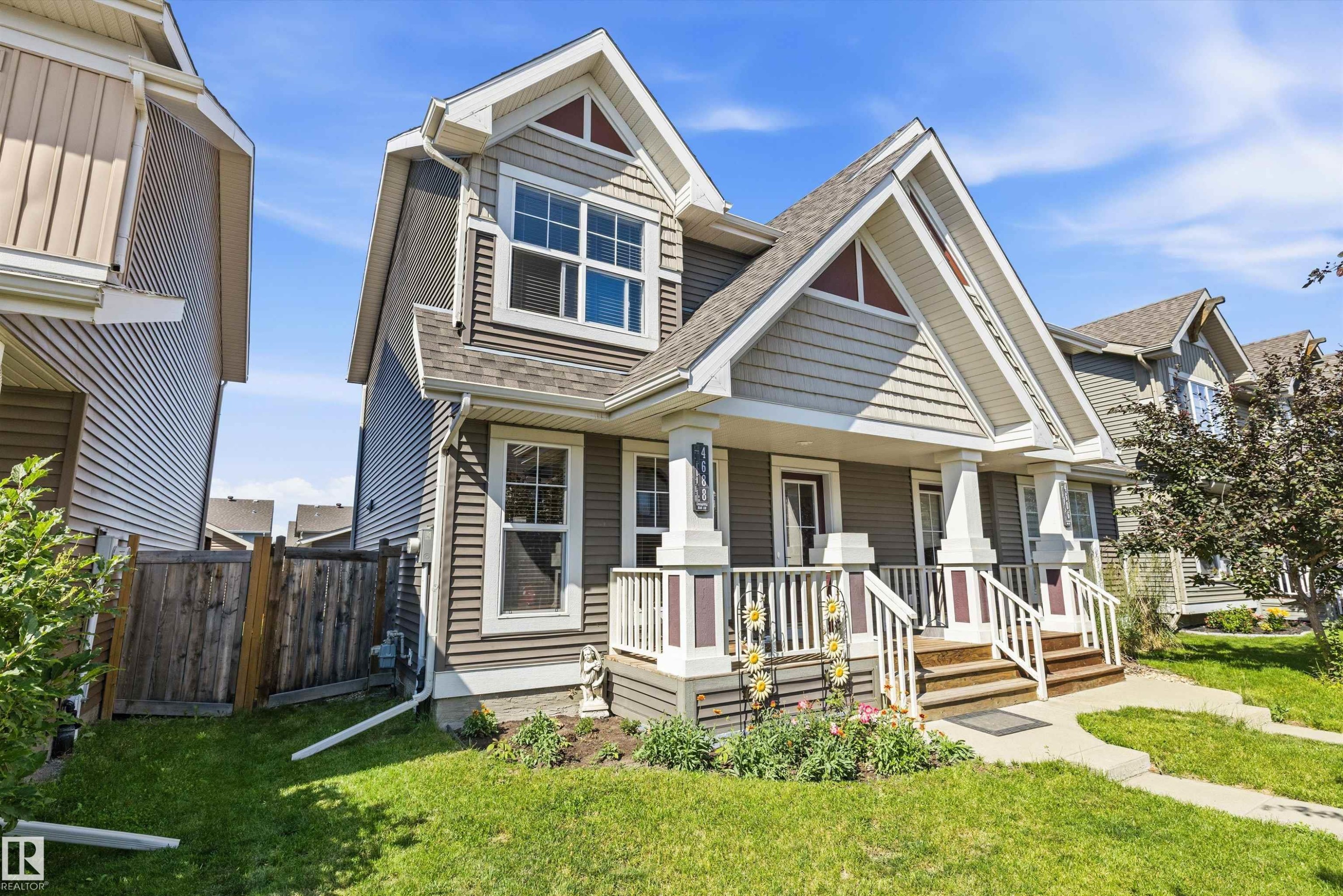 Gable-front home featuring gray siding with white trim accents and a covered porch - 4688 Crabapple Run Sw, Edmonton, AB - Outdoor With Facade