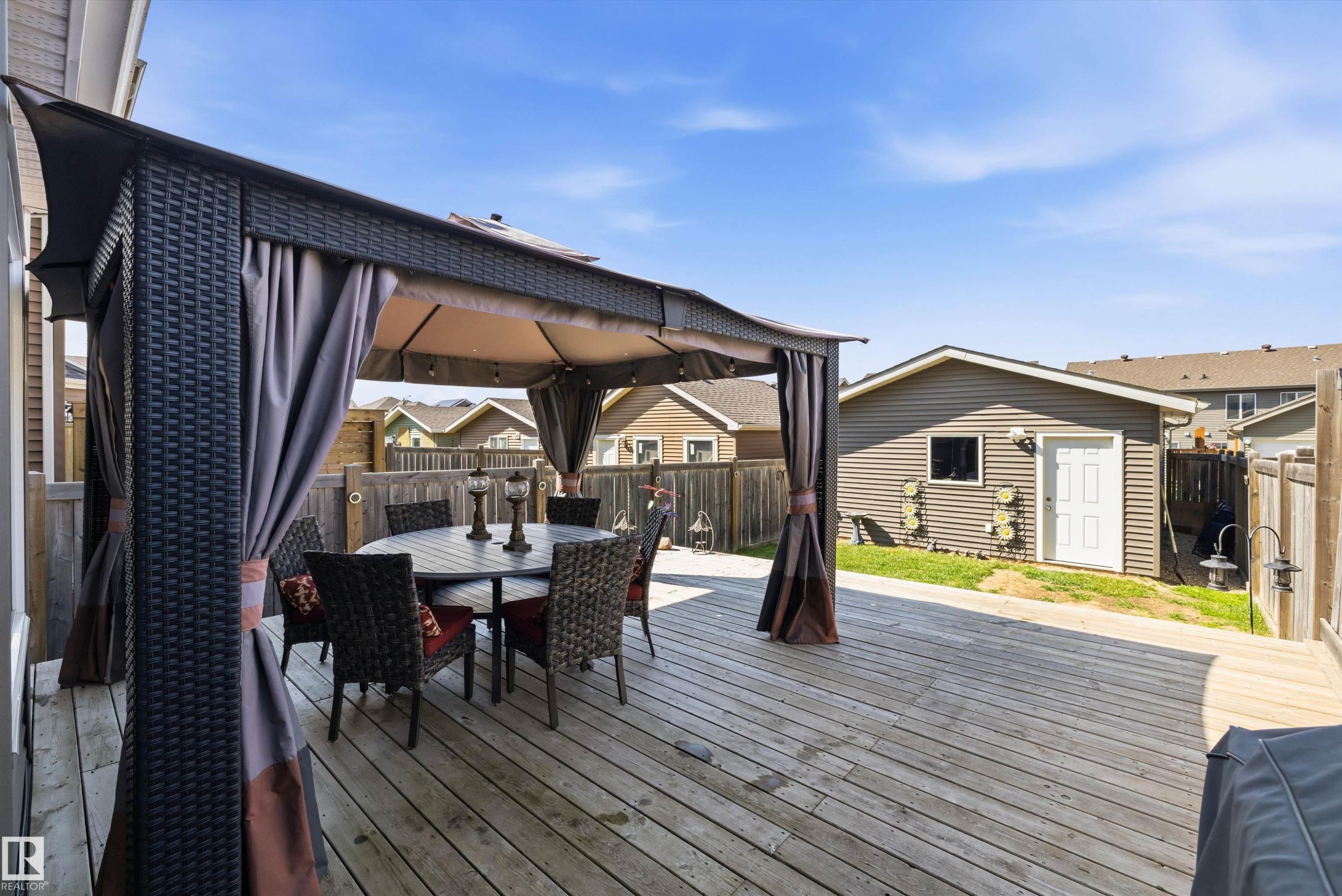 Spacious outdoor deck featuring a gazebo, privacy curtains, and ample room for seating - 4688 Crabapple Run Sw, Edmonton, AB - Outdoor With Exterior