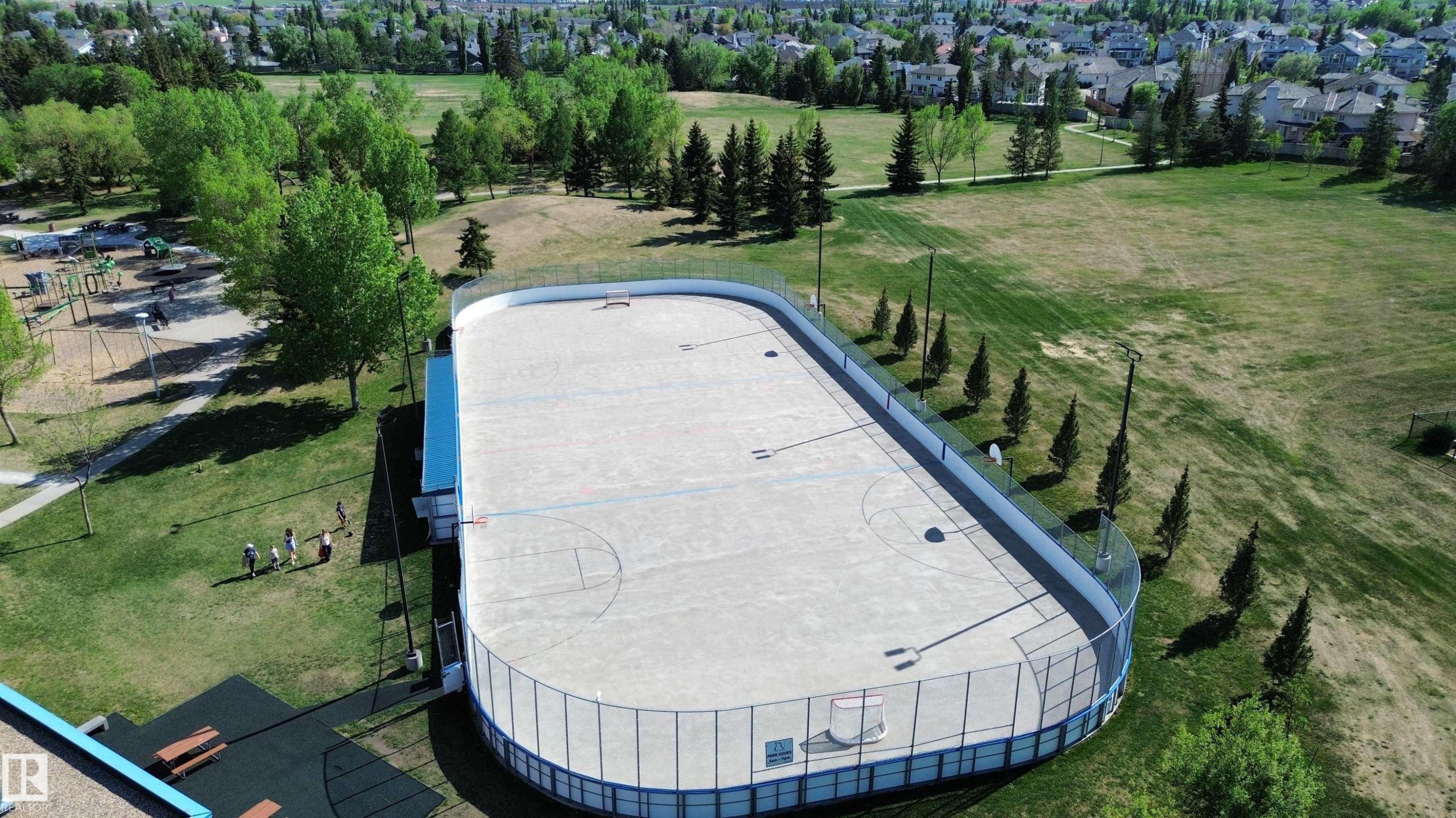 Expansive outdoor rink with basketball markings and surrounding safety netting - 11347 10 Avenue, Edmonton, AB - Outdoor