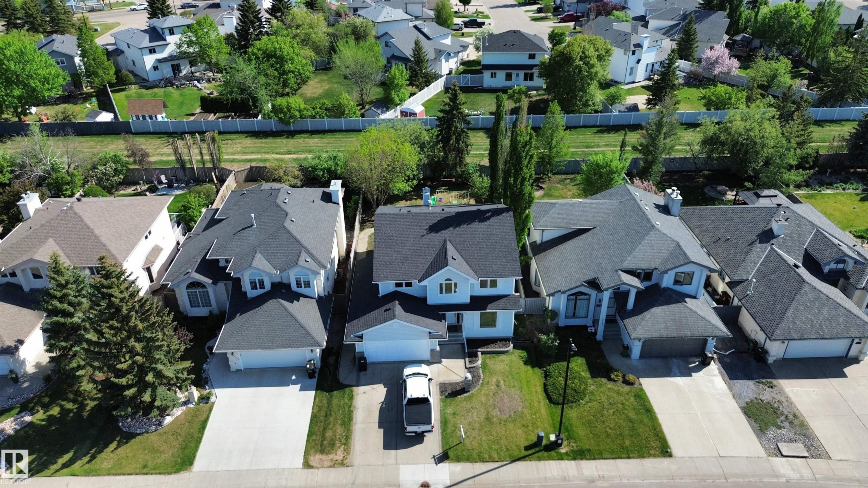 Two-story residence with a light-colored exterior and dark shingle roofing - 11347 10 Avenue, Edmonton, AB - Outdoor With Facade