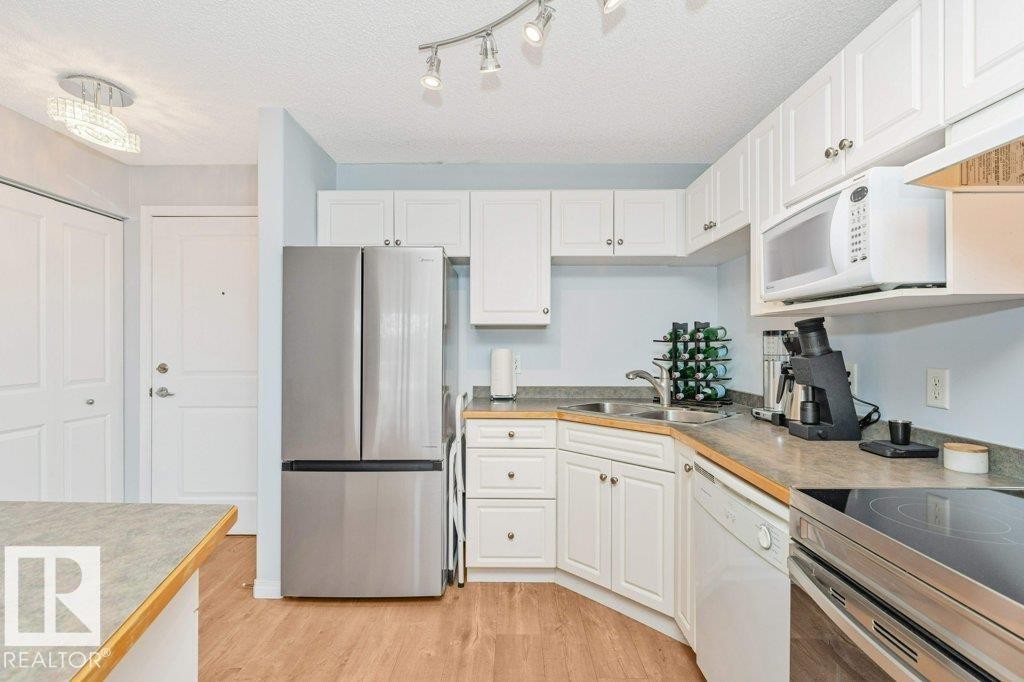 #217 245 Edwards Dr Sw, Edmonton, AB - Indoor Photo Showing Kitchen With Stainless Steel Kitchen With Double Sink