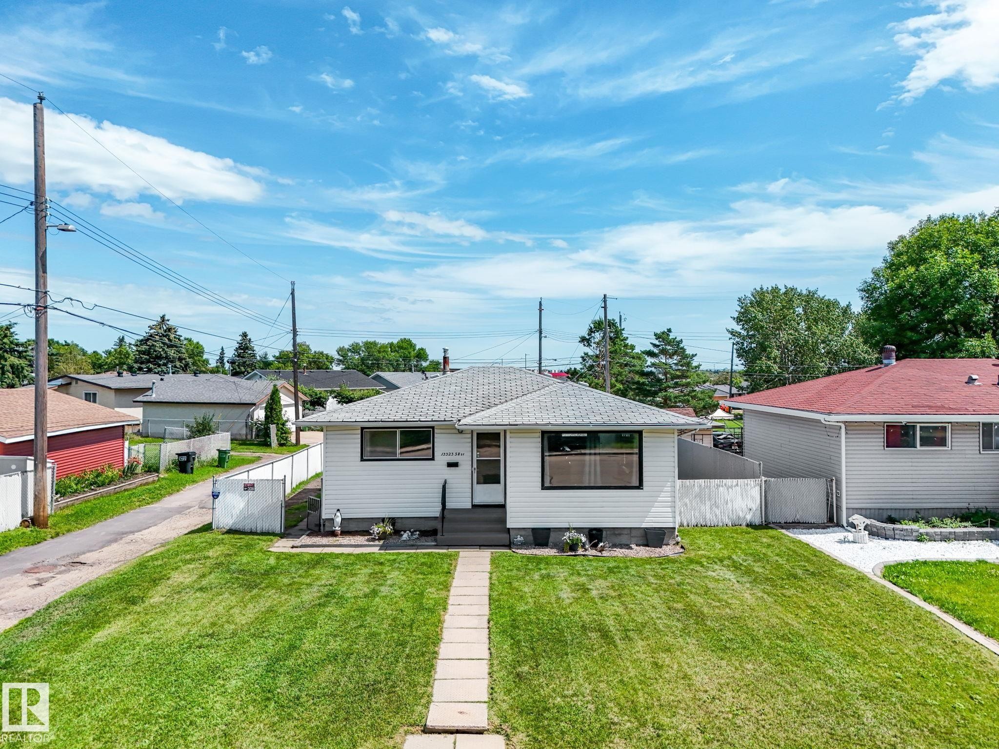 White siding exterior with black-trimmed windows - 13323 58 Street Nw, Edmonton, AB - Outdoor