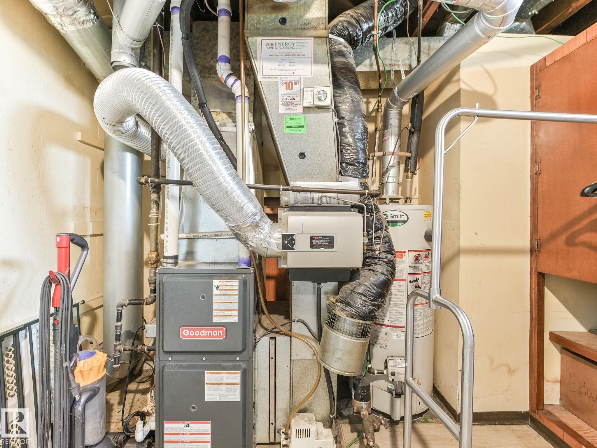 Goodman furnace and Smith hot water heater within the utility area - 13323 58 Street Nw, Edmonton, AB - Indoor Photo Showing Basement