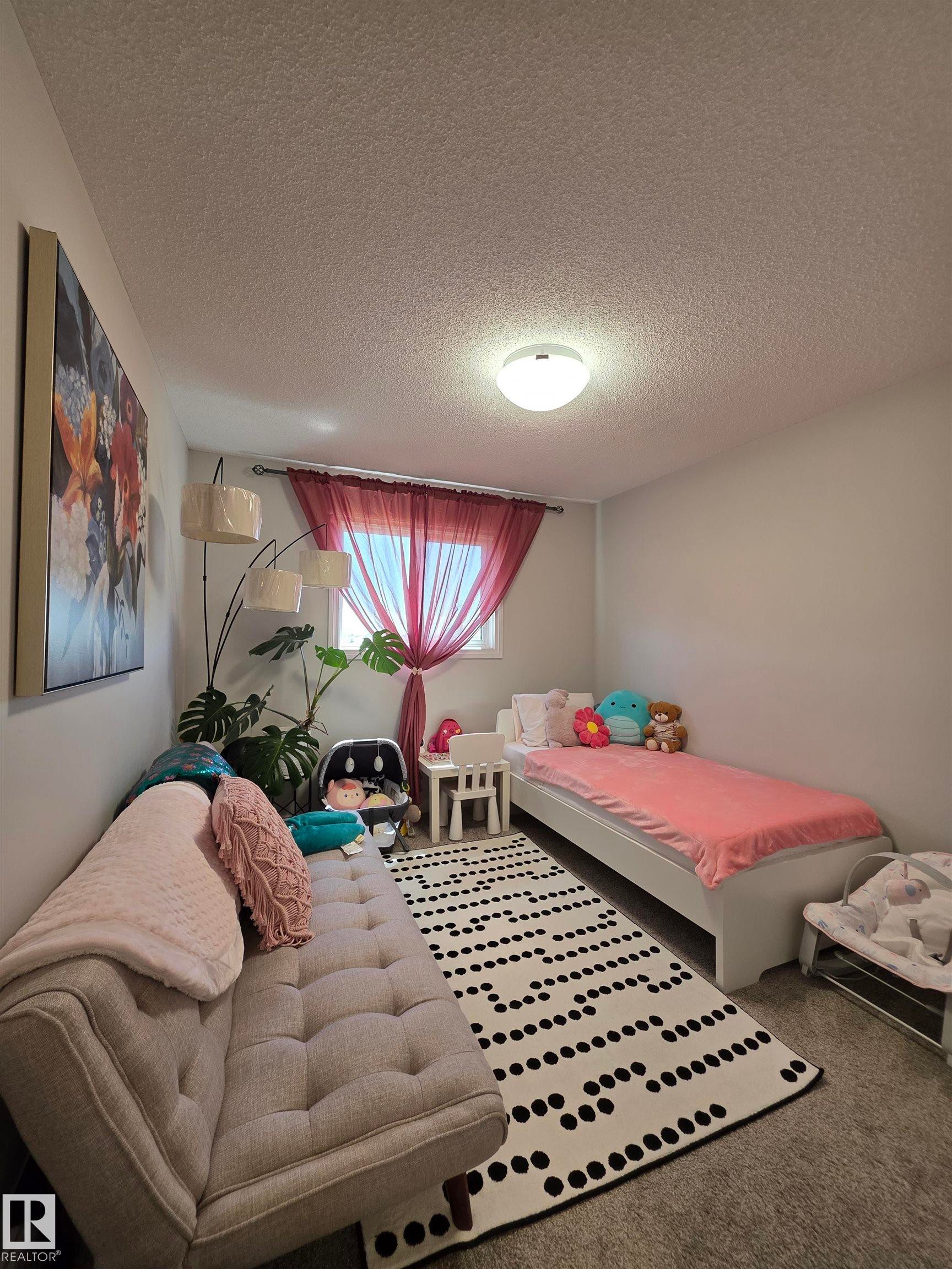 White walls and textured ceiling with flush-mount lighting - 491 Ebbers Way, Edmonton, AB