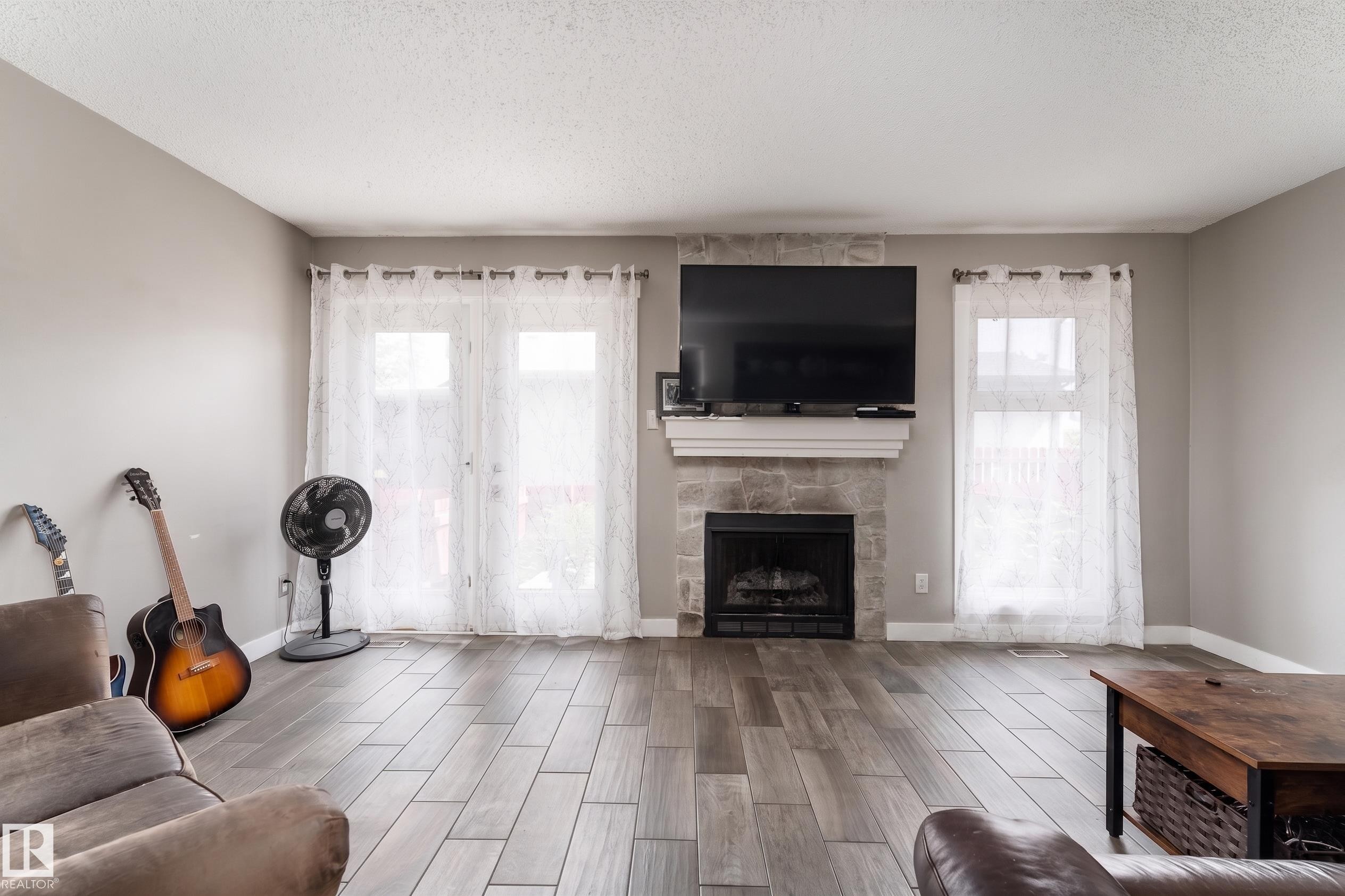 #2 4707 126 Av Nw, Edmonton, AB - Indoor Photo Showing Living Room With Fireplace