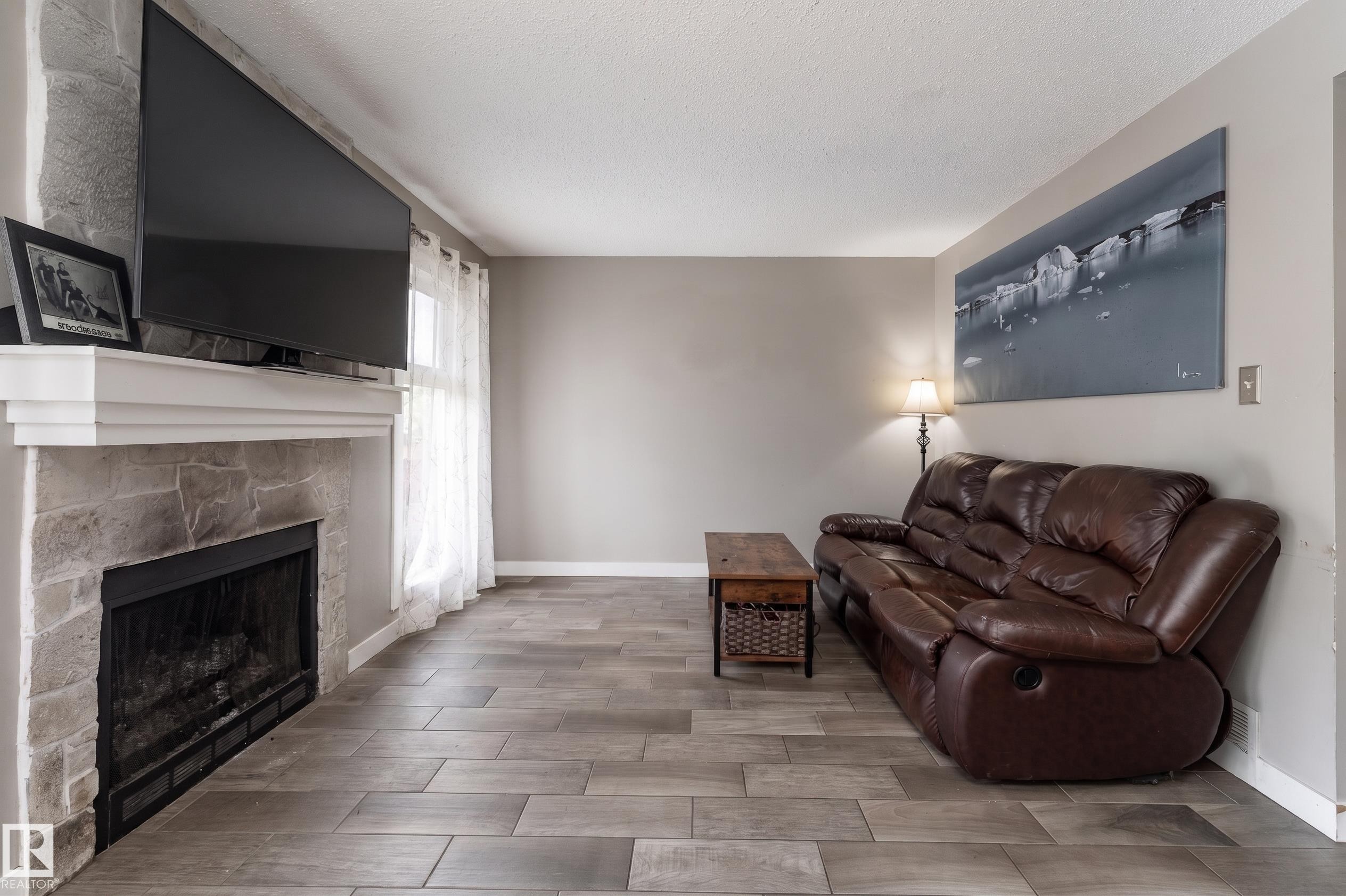 #2 4707 126 Av Nw, Edmonton, AB - Indoor Photo Showing Living Room With Fireplace