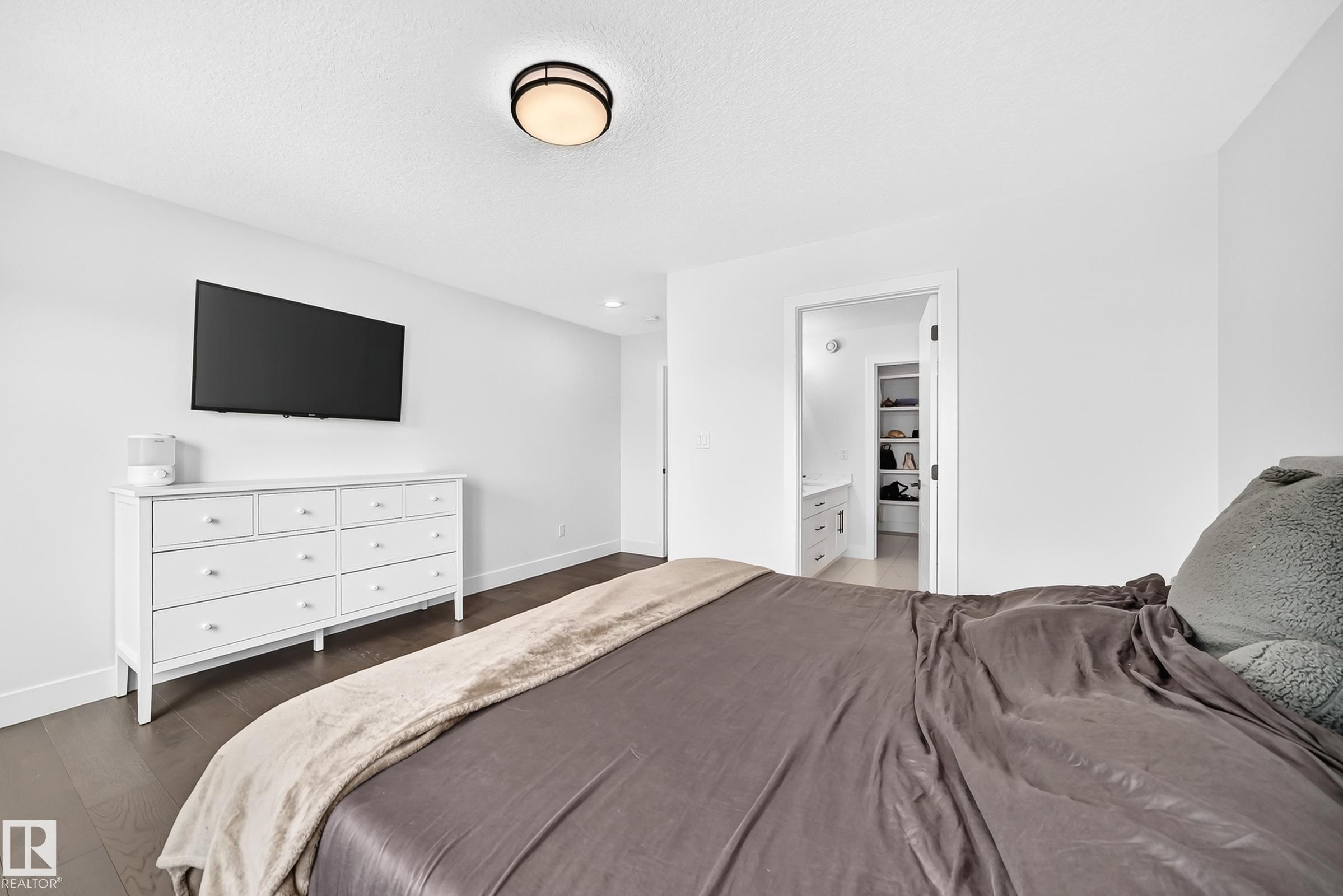 Bedroom featuring dark wood-finish flooring and white baseboards - 22270 99A Avenue Nw, Edmonton, AB - Indoor Photo Showing Bedroom