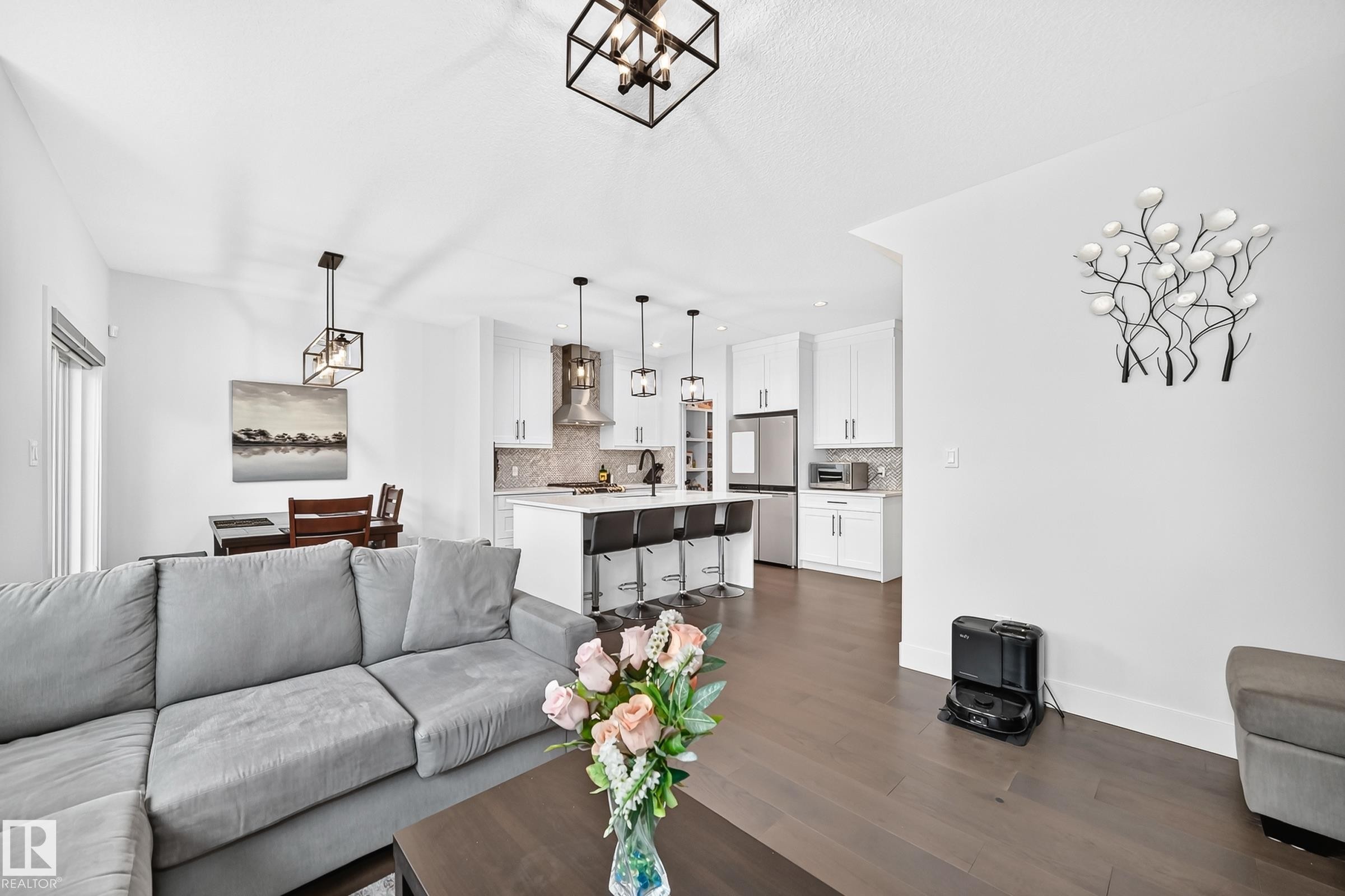 Open-concept living space featuring wood-finish flooring throughout - 22270 99A Avenue Nw, Edmonton, AB - Indoor Photo Showing Living Room