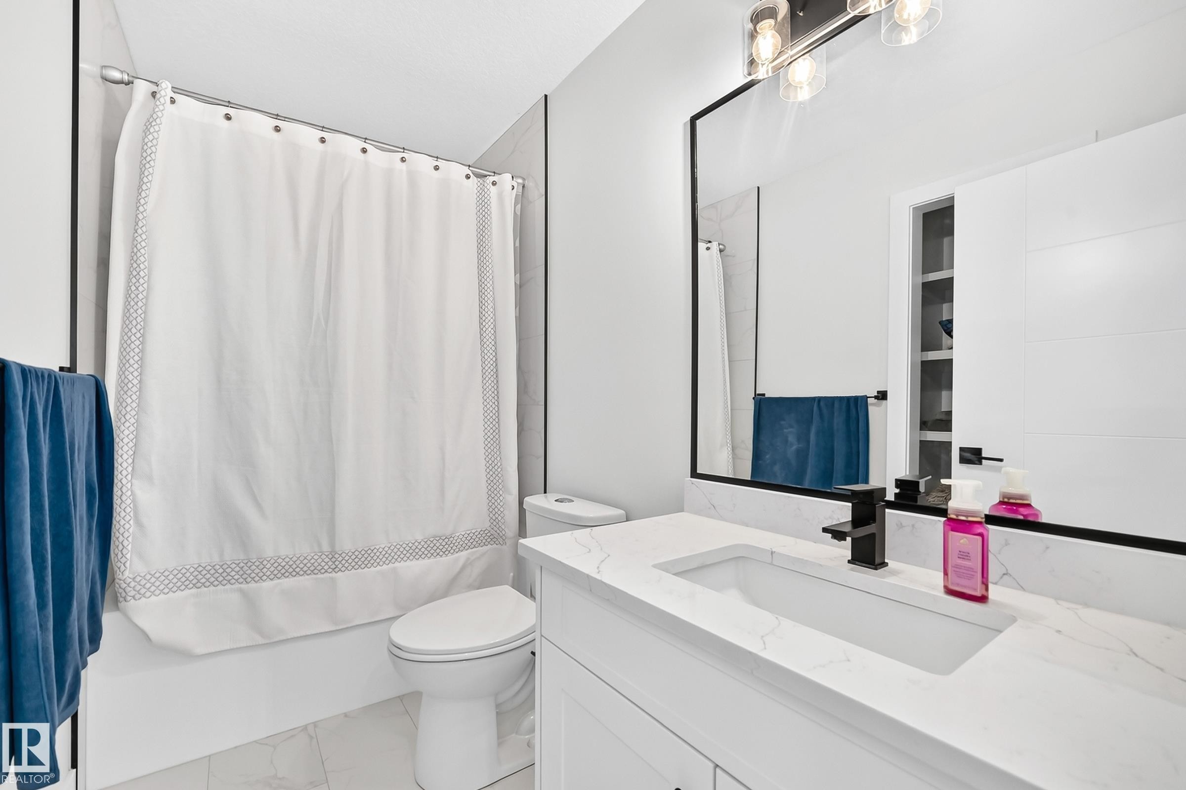 Contemporary bathroom featuring a white vanity with a rectangular undermount sink and a stone-finish countertop - 22270 99A Avenue Nw, Edmonton, AB - Indoor Photo Showing Bathroom