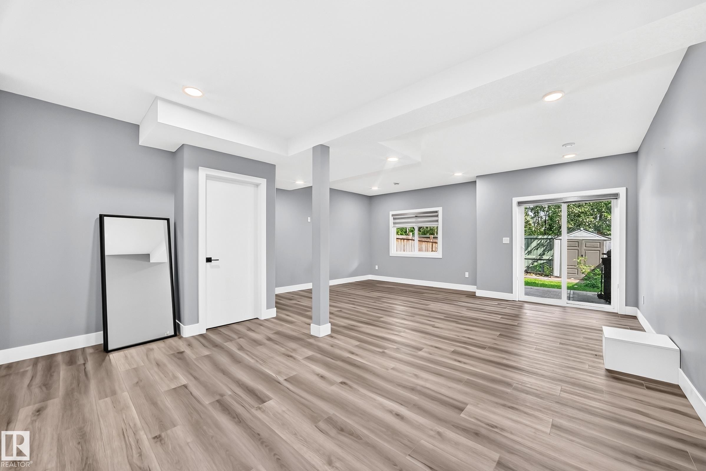 Spacious room featuring wood-finish flooring, recessed lighting, and light gray walls - 22270 99A Avenue Nw, Edmonton, AB - Indoor Photo Showing Other Room