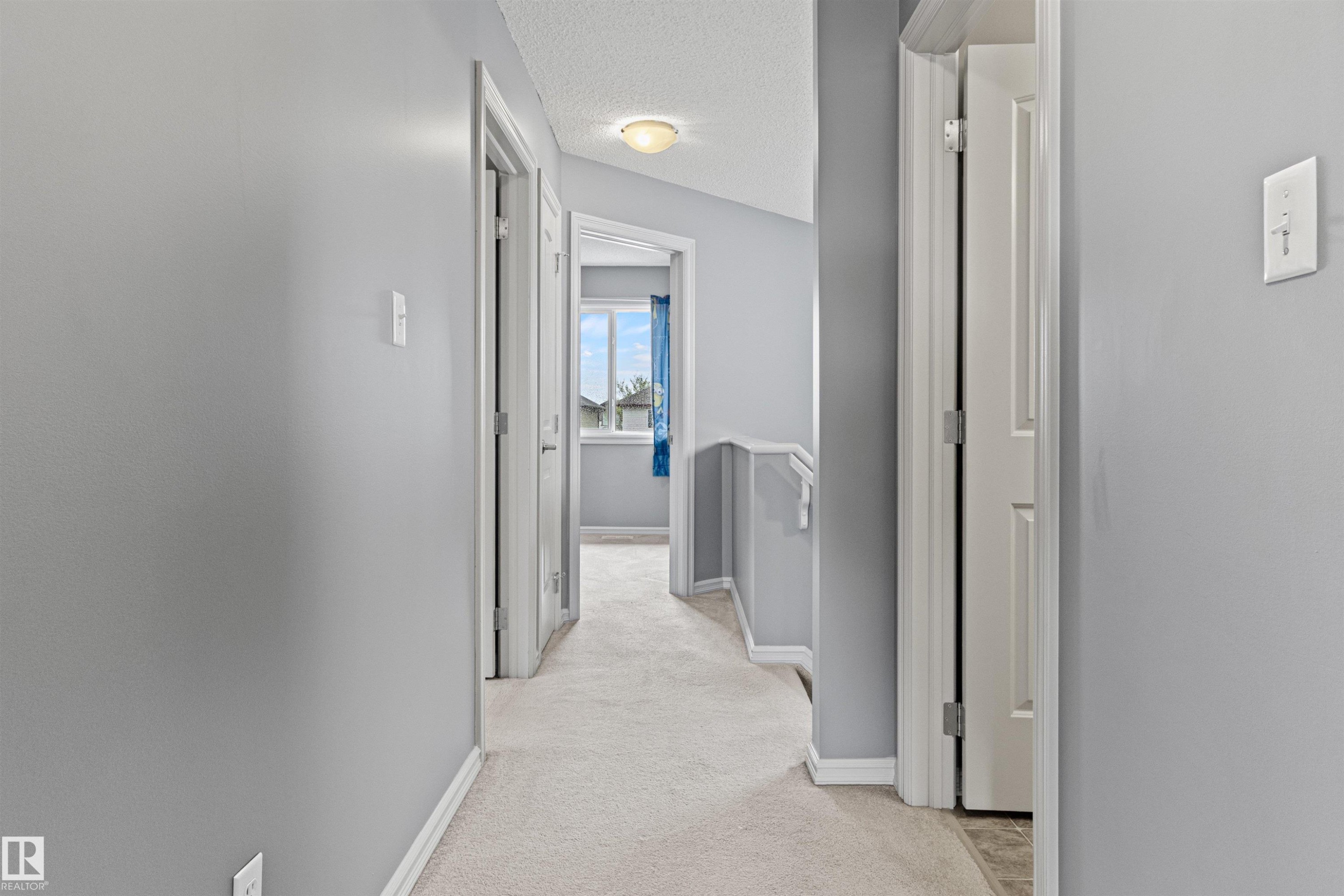 Upper-level hallway with light gray walls, white trim, and light-colored carpet flooring - 1154 35A Avenue Nw, Edmonton, AB - Indoor Photo Showing Other Room