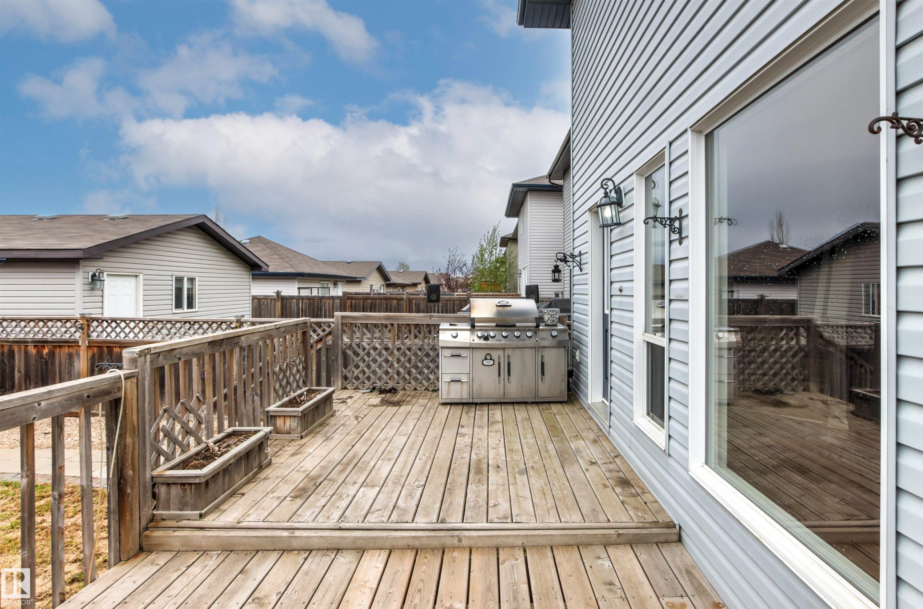 Wooden deck with railing, featuring a built-in outdoor cooking station - 1154 35A Avenue Nw, Edmonton, AB - Outdoor With Deck Patio Veranda With Exterior