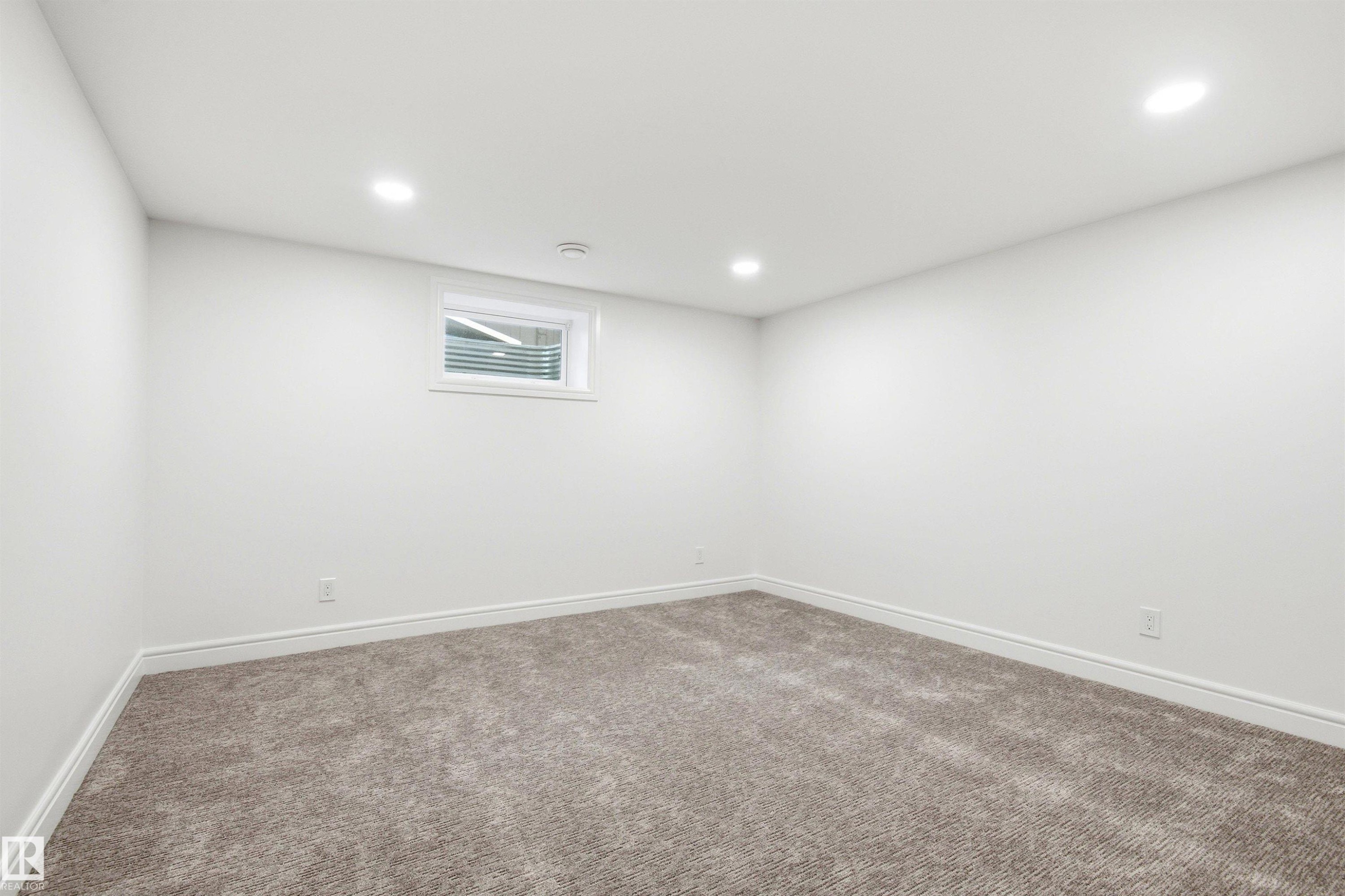 Room featuring neutral carpeting, white walls, and recessed lighting - 14335 47 Avenue Nw, Edmonton, AB - Indoor