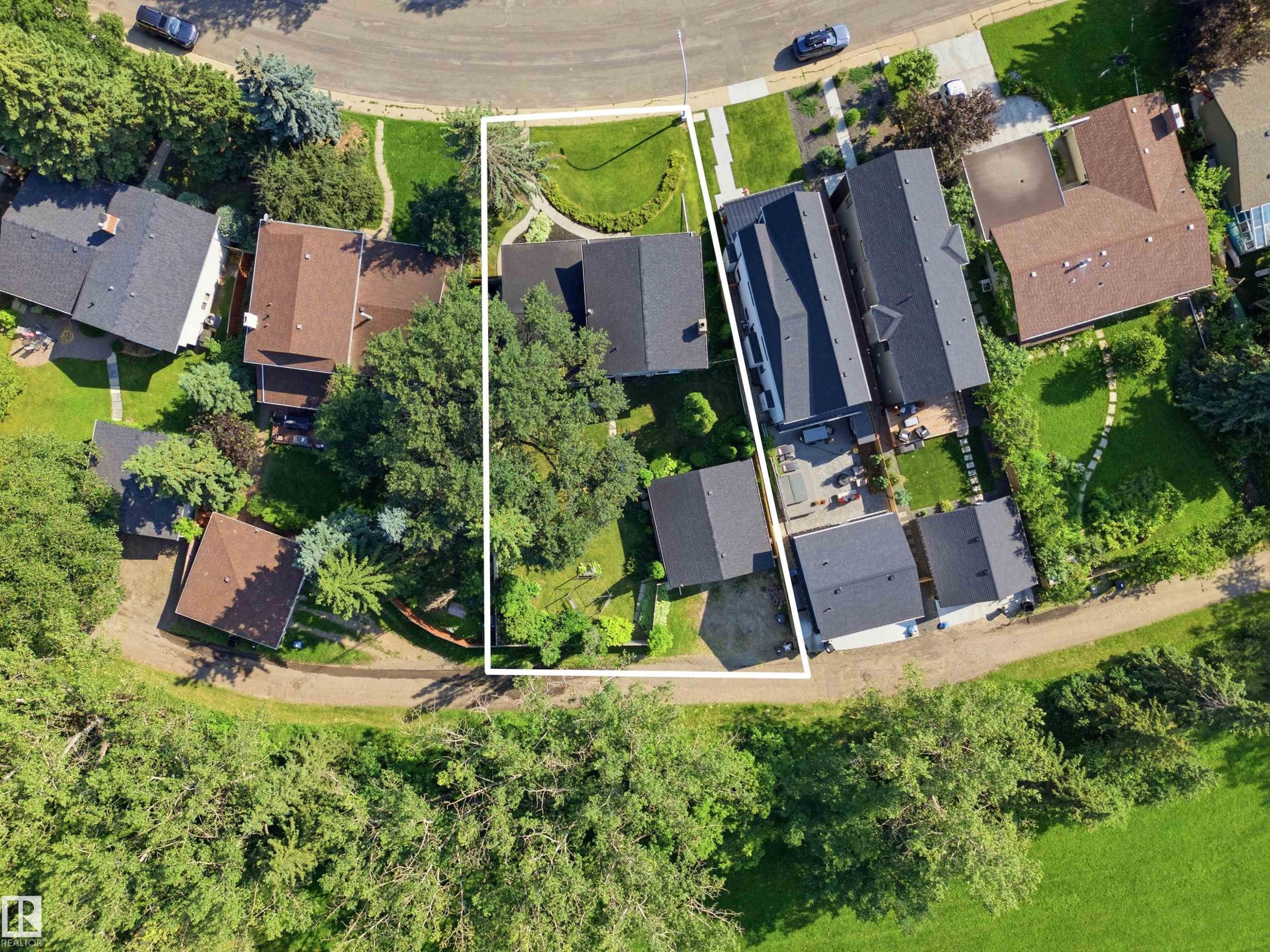 Aerial perspective showcasing a large residential property with mature trees, expansive green spaces, and direct access to a natural greenbelt - 14335 47 Avenue Nw, Edmonton, AB - Outdoor With View