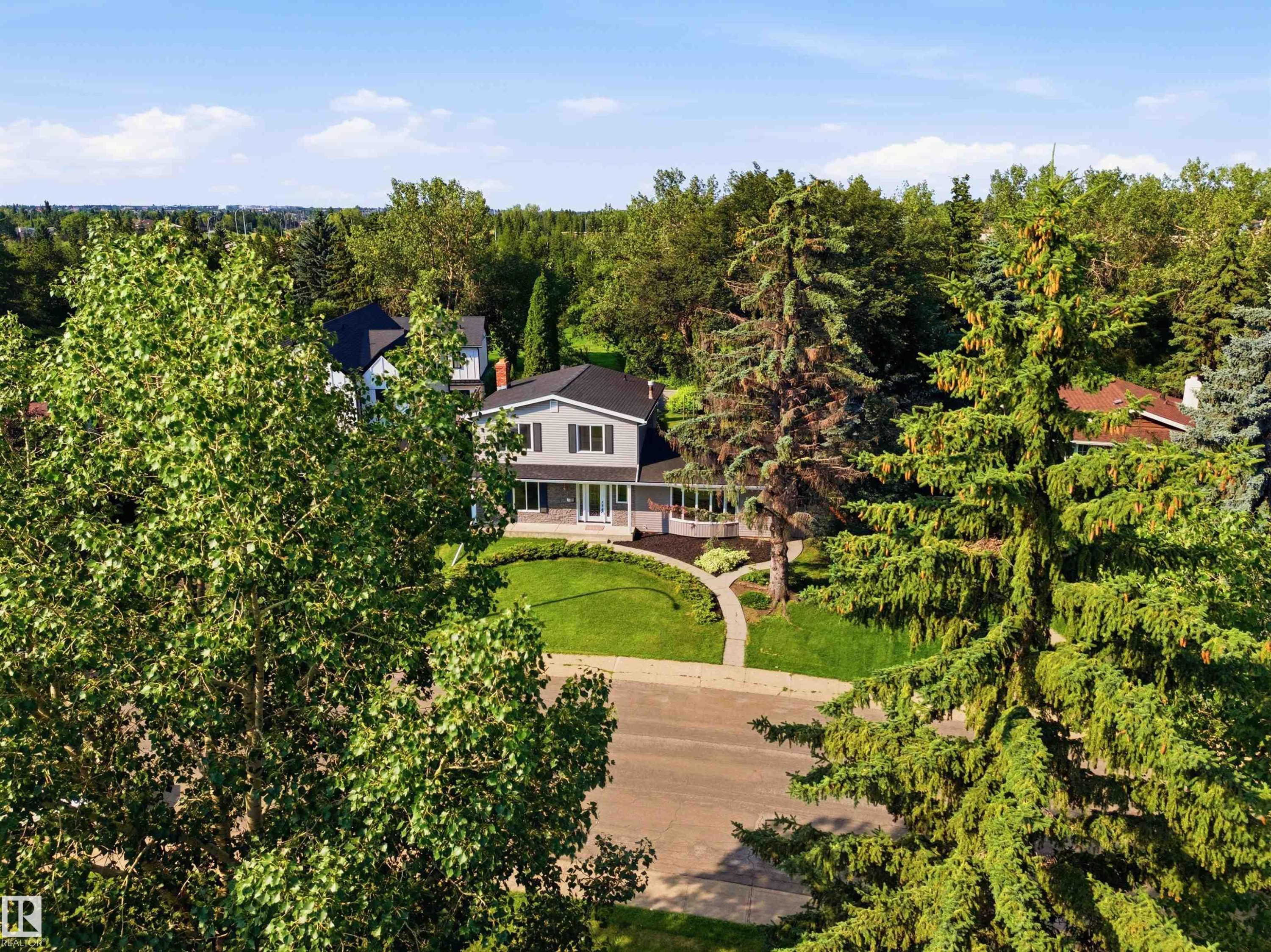 Traditional-style residence featuring grey siding with dark shutters, a dark roof, and a prominent front porch - 14335 47 Avenue Nw, Edmonton, AB - Outdoor