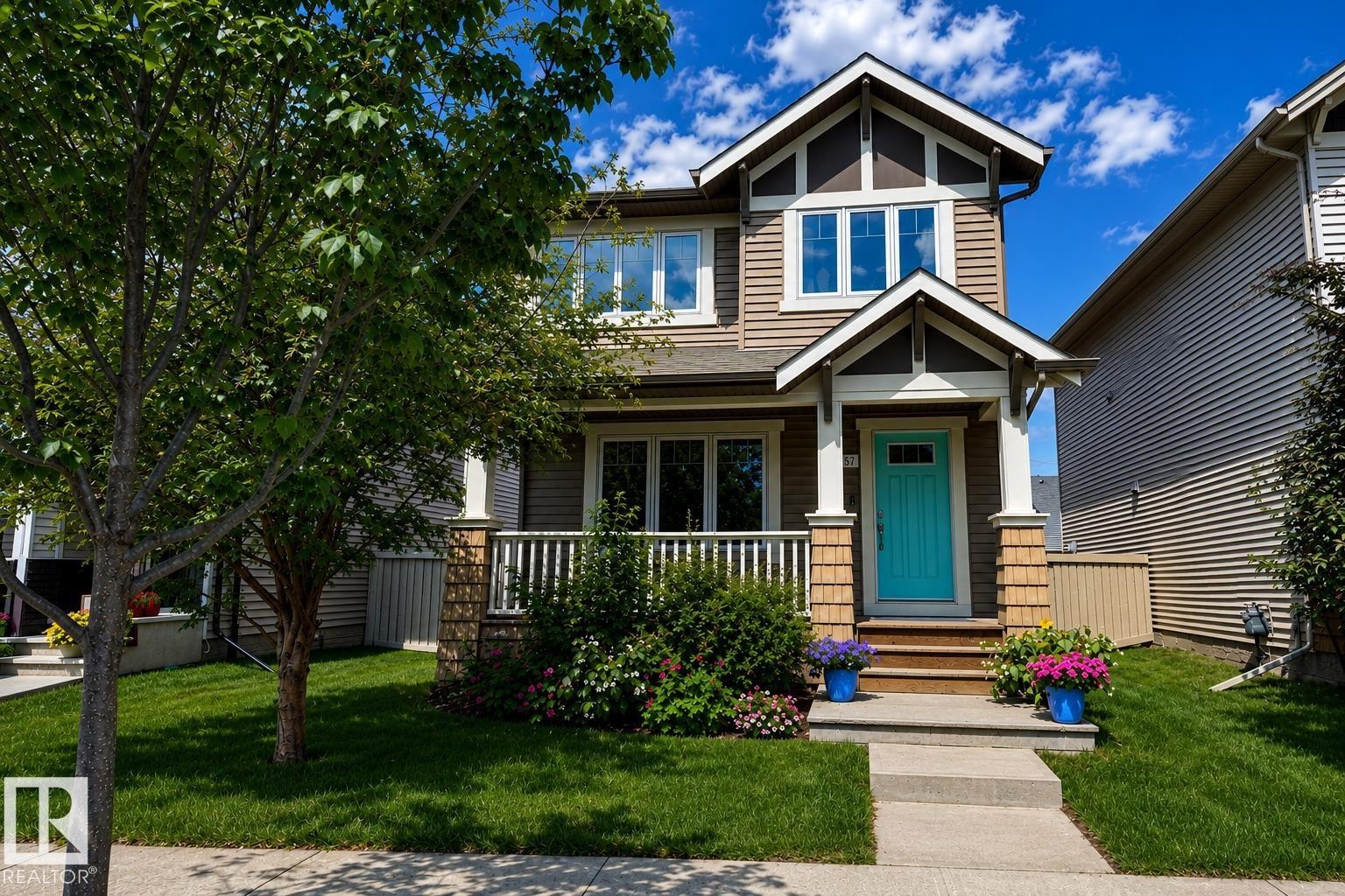 Craftsman-style home featuring a bright turquoise front door - 3457 Cutler Crescent Sw, Edmonton, AB - Outdoor With Facade
