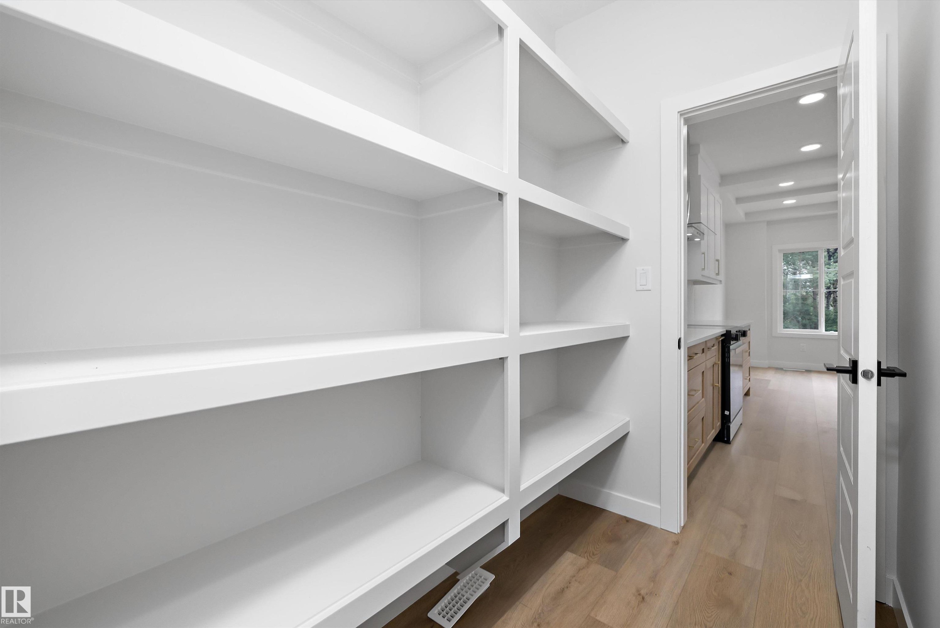Built-in white shelving system with multiple tiers - 919 Elderberry Landing Nw, Edmonton, AB - Indoor With Storage