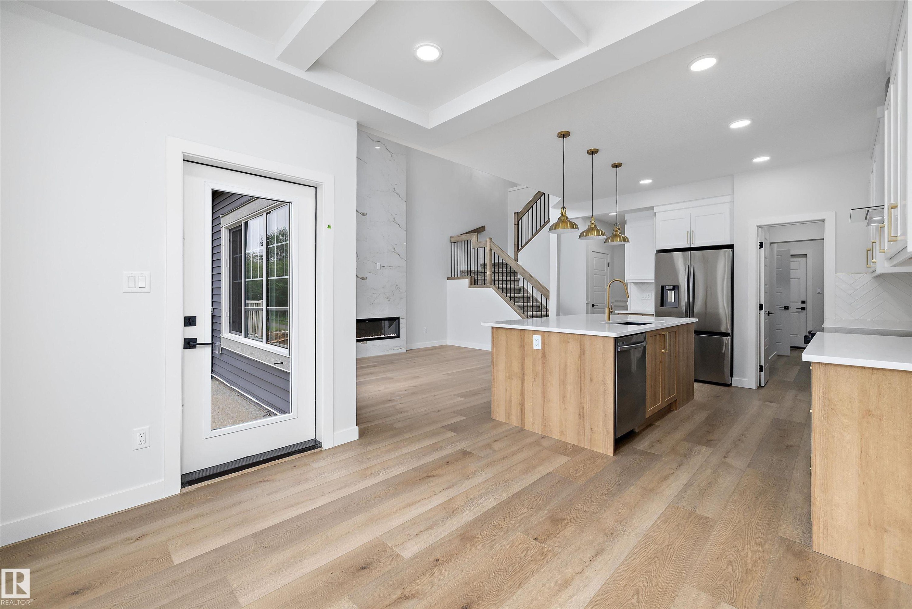 Open-concept living area with wood-finish flooring - 919 Elderberry Landing Nw, Edmonton, AB - Indoor Photo Showing Kitchen
