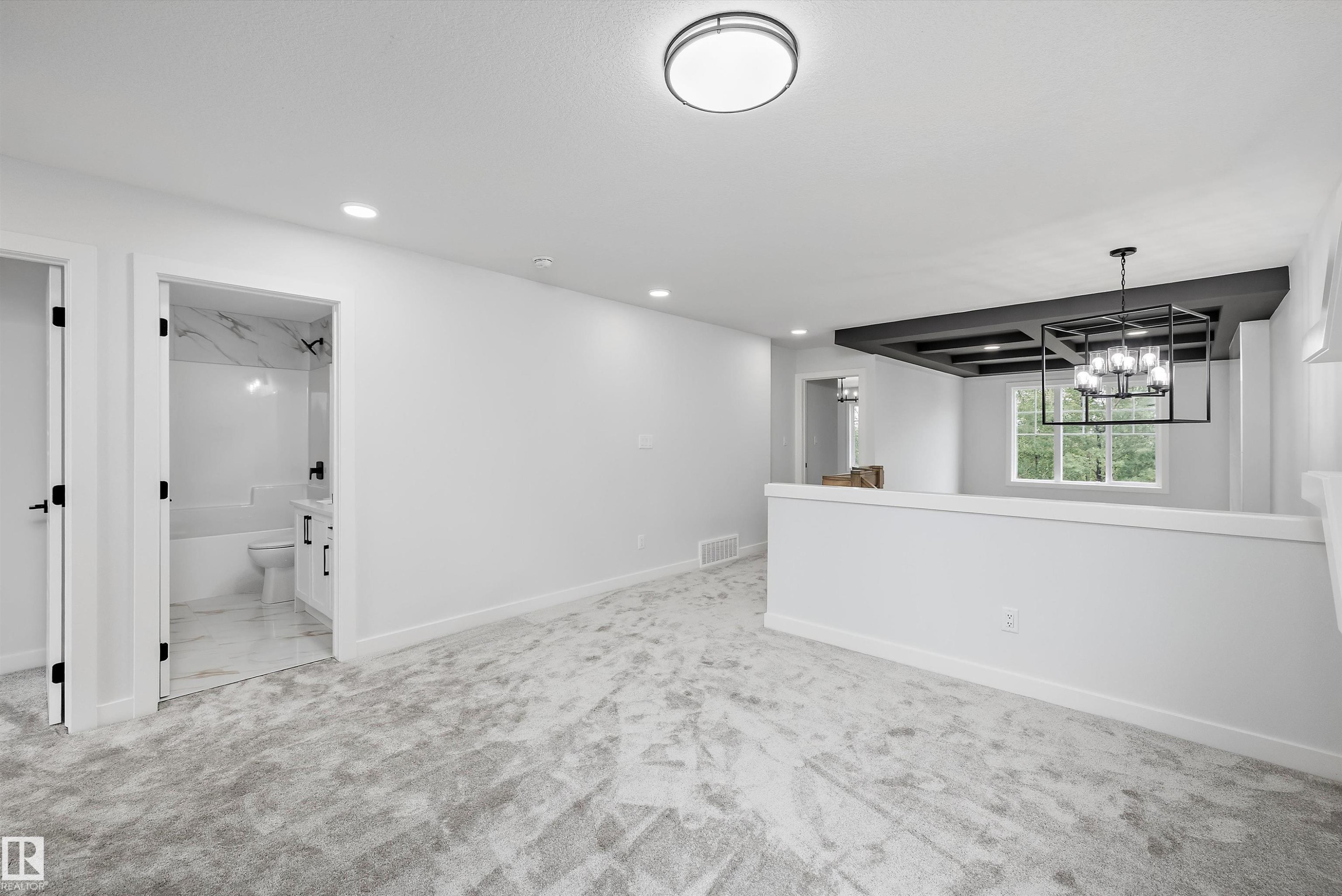 Carpeted landing area featuring a contemporary flush-mount ceiling light and recessed lighting - 919 Elderberry Landing Nw, Edmonton, AB - Indoor Photo Showing Other Room
