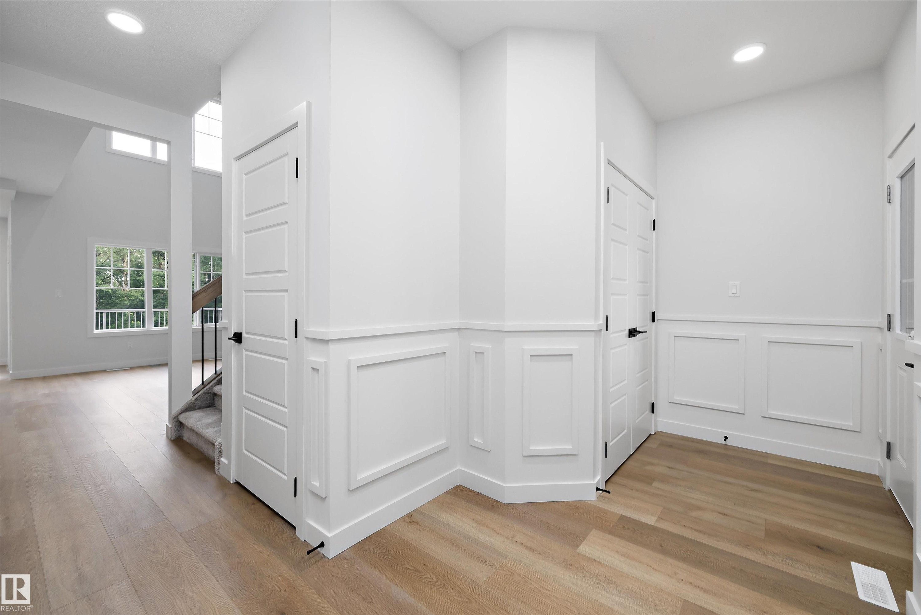Foyer featuring light wood-finish flooring, white paneling, and recessed lighting - 919 Elderberry Landing Nw, Edmonton, AB - Indoor Photo Showing Other Room