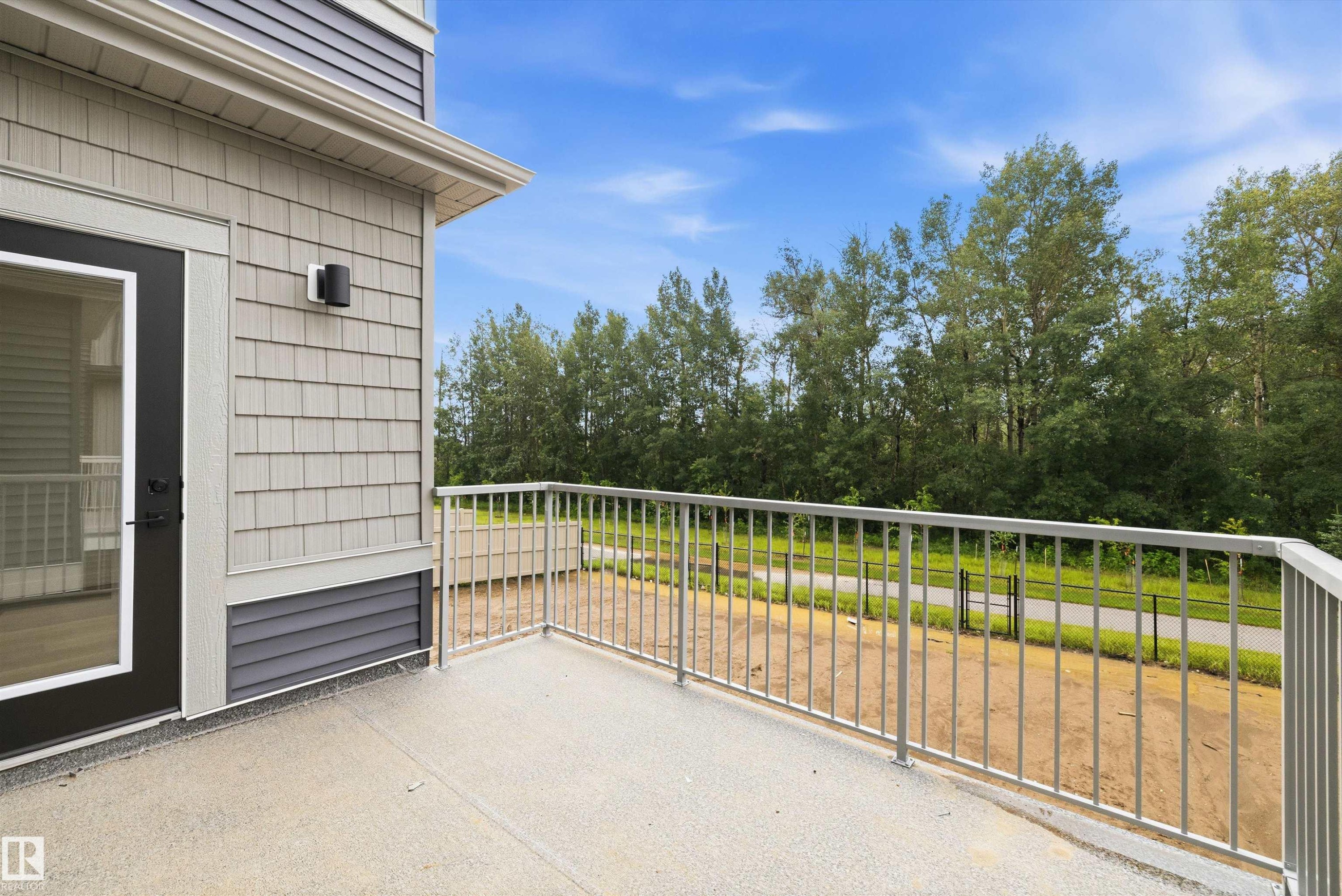 Outdoor balcony featuring a gray textured floor and metal railing - 919 Elderberry Landing Nw, Edmonton, AB - Outdoor With Exterior