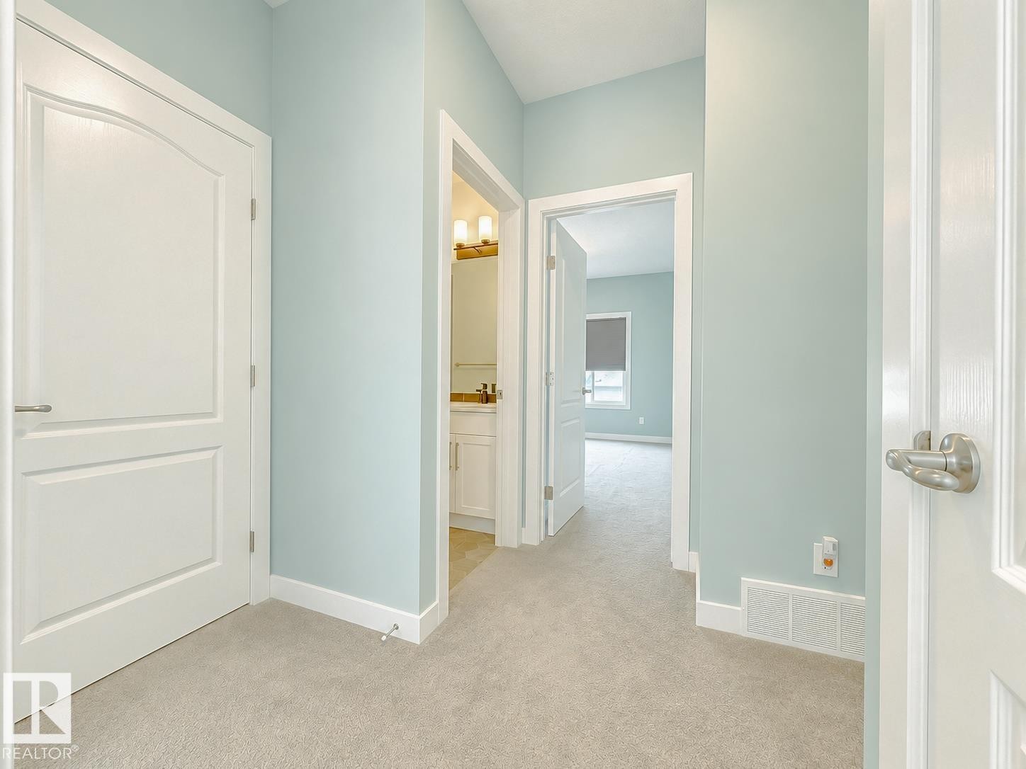 Carpeted hallway with light blue walls and white trim - #56 804 Welsh Dr Sw, Edmonton, AB - Indoor Photo Showing Other Room