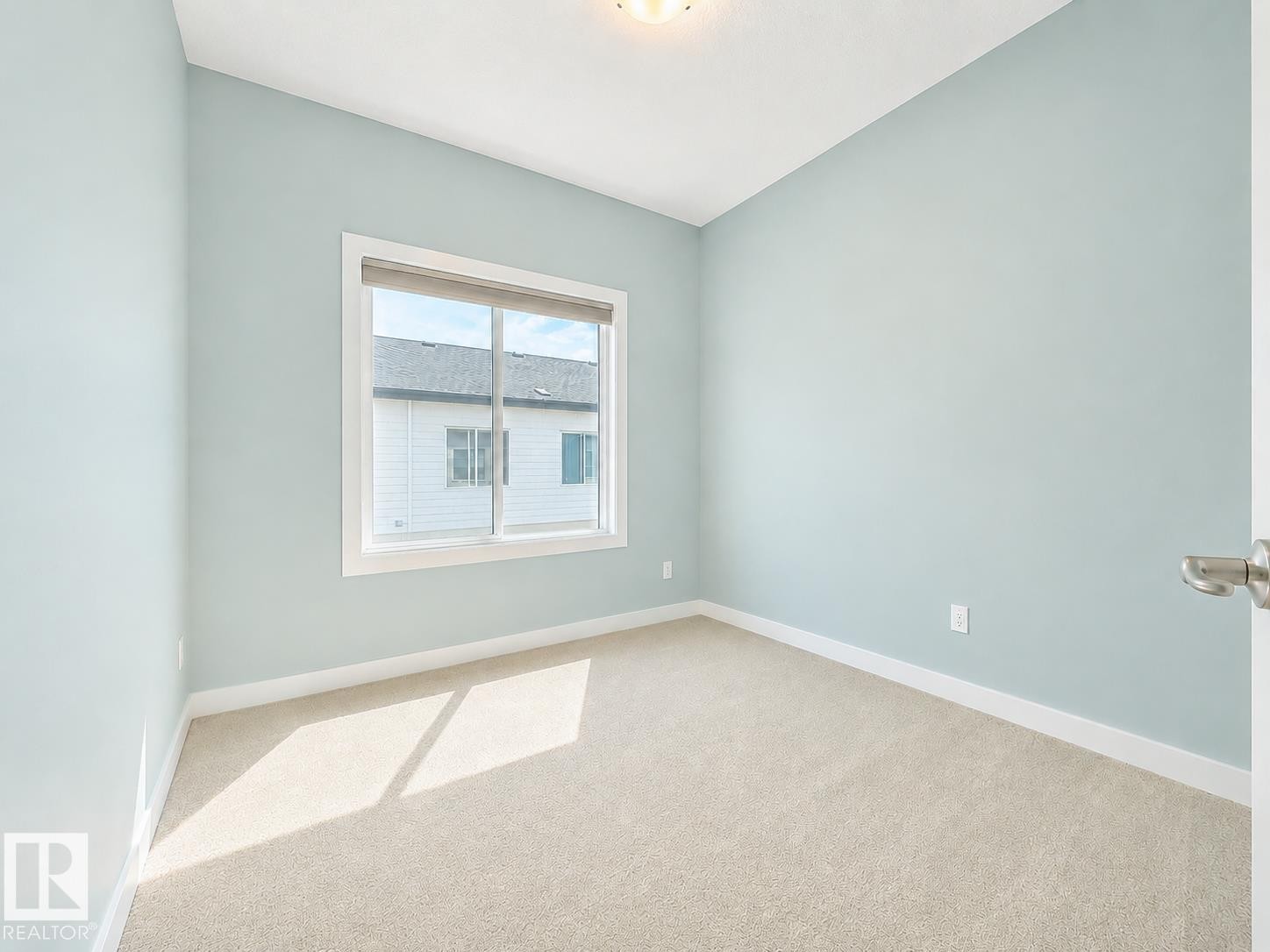 Light blue walls, white trim, and neutral carpet - #56 804 Welsh Dr Sw, Edmonton, AB - Indoor Photo Showing Other Room