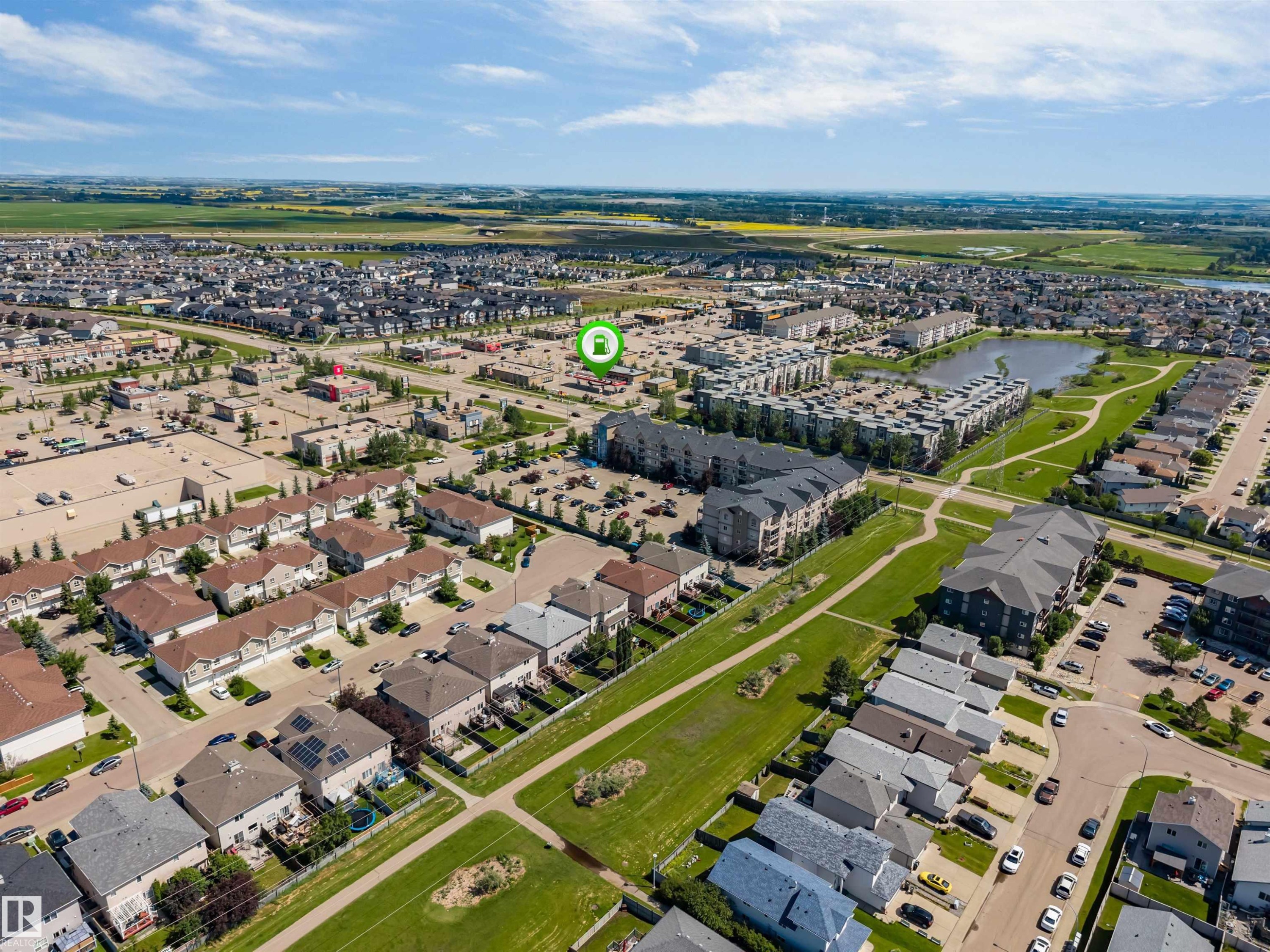 Aerial perspective showcasing a residential community with diverse housing types - 16205 55 Street Nw, Edmonton, AB - Outdoor With View