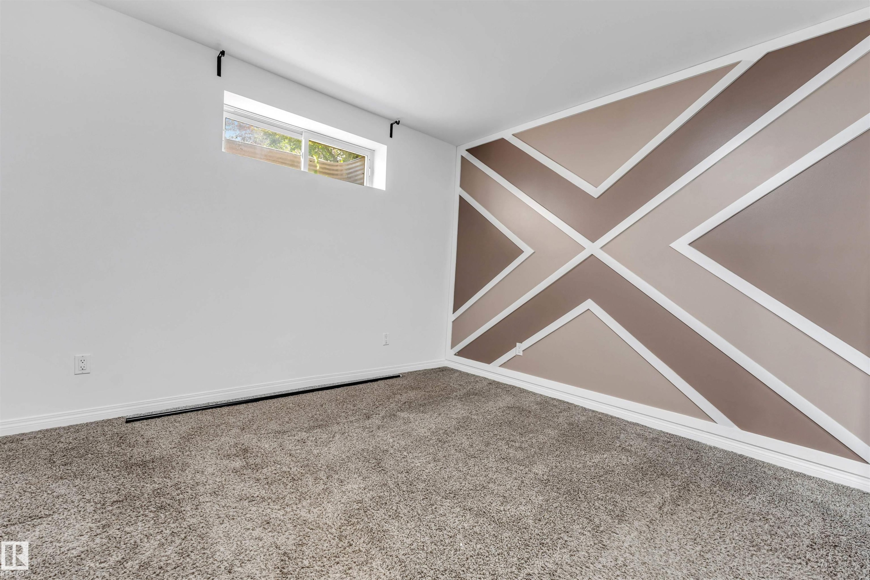 Architectural accent wall featuring geometric paneling in varying earth tones - 16205 55 Street Nw, Edmonton, AB - Indoor Photo Showing Other Room