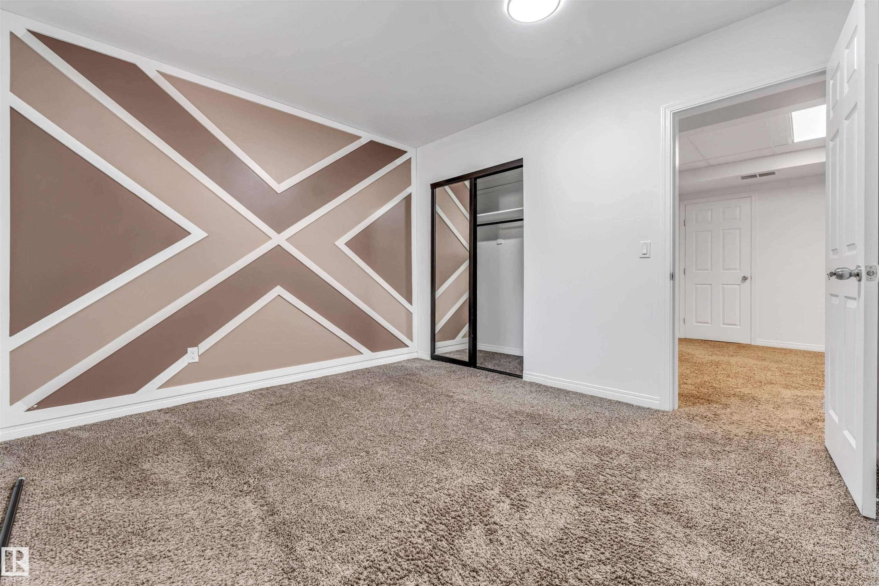 Accent wall featuring geometric paneling - 16205 55 Street Nw, Edmonton, AB - Indoor Photo Showing Other Room