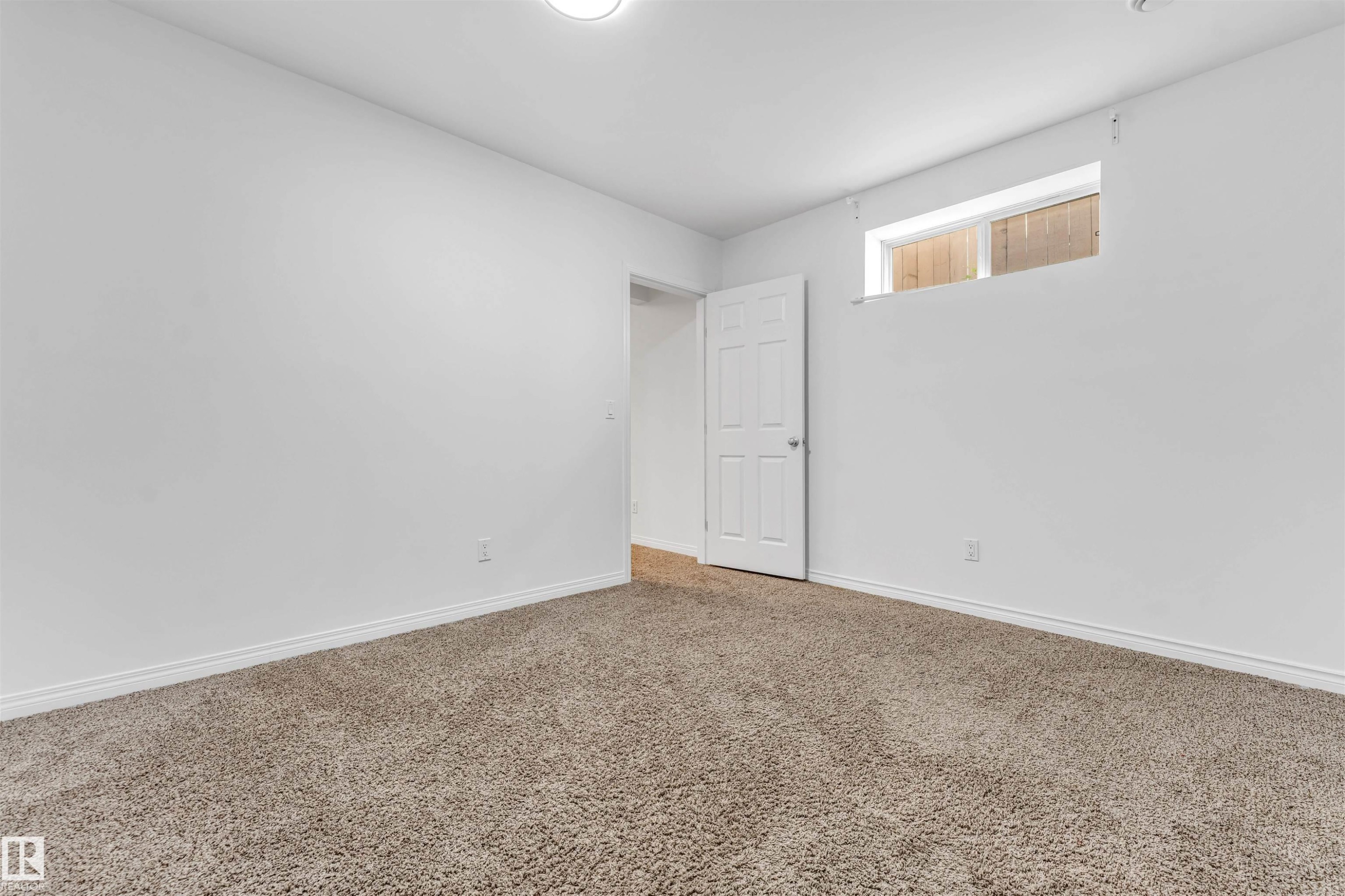 Room with neutral carpet flooring, white walls, and white baseboards - 16205 55 Street Nw, Edmonton, AB - Indoor Photo Showing Other Room
