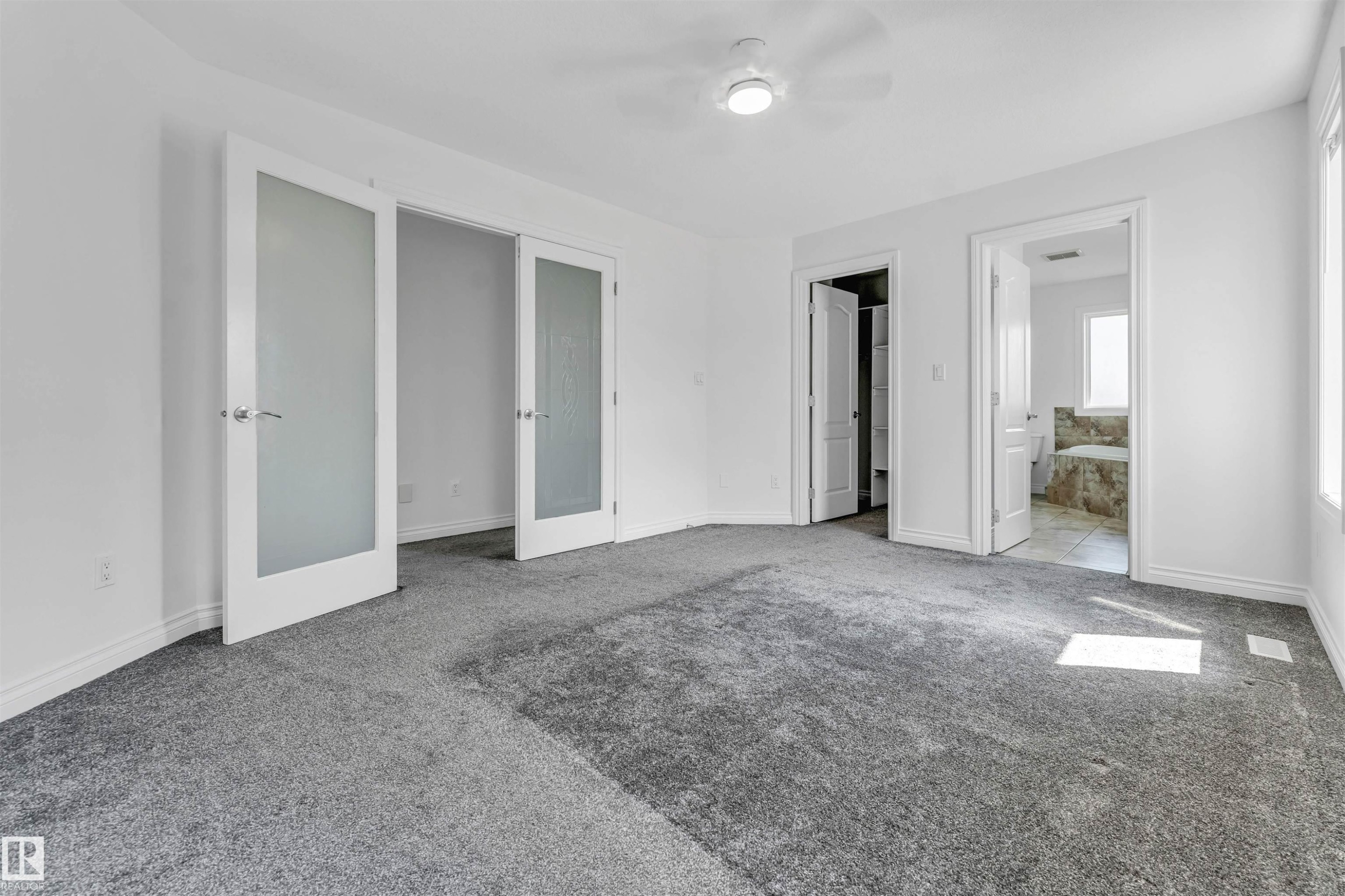Spacious room with gray carpeting and white walls - 16205 55 Street Nw, Edmonton, AB - Indoor Photo Showing Other Room