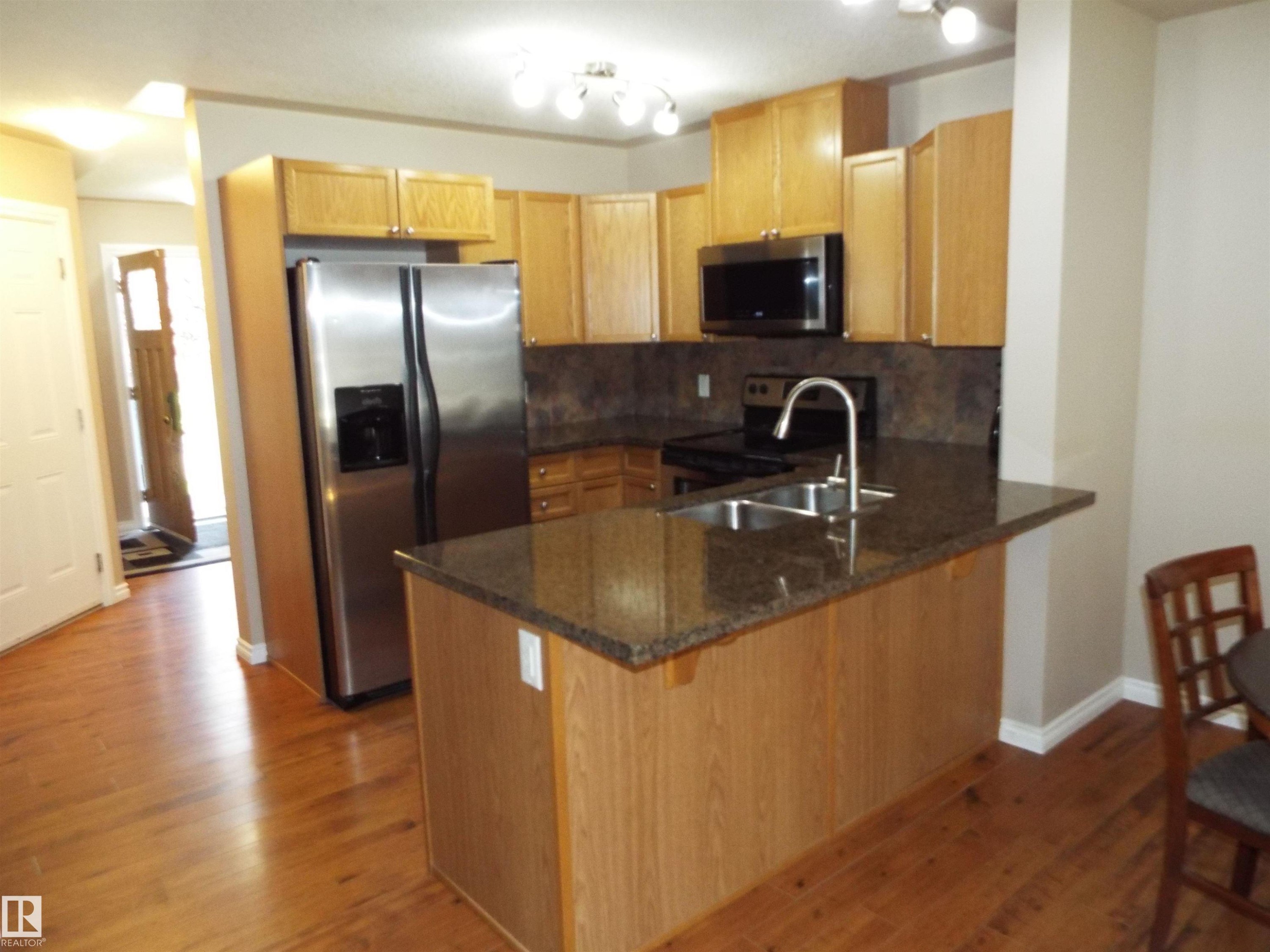#133 5420 Grant Macewan Bv, Leduc, AB - Indoor Photo Showing Kitchen With Double Sink