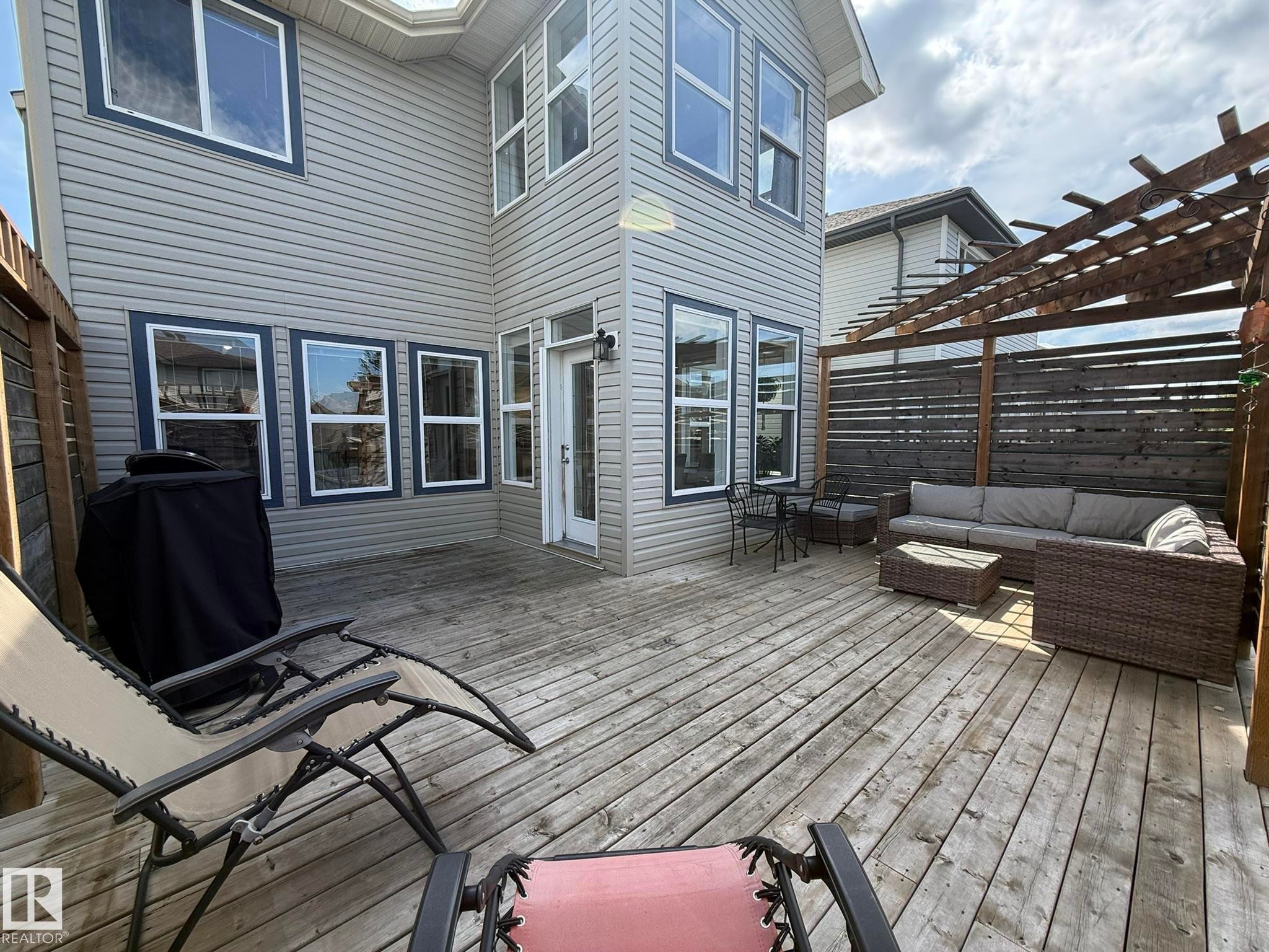 Spacious wood deck with a built-in pergola and privacy screen - 1820 Robertson Crescent Sw, Edmonton, AB - Outdoor With Deck Patio Veranda With Exterior
