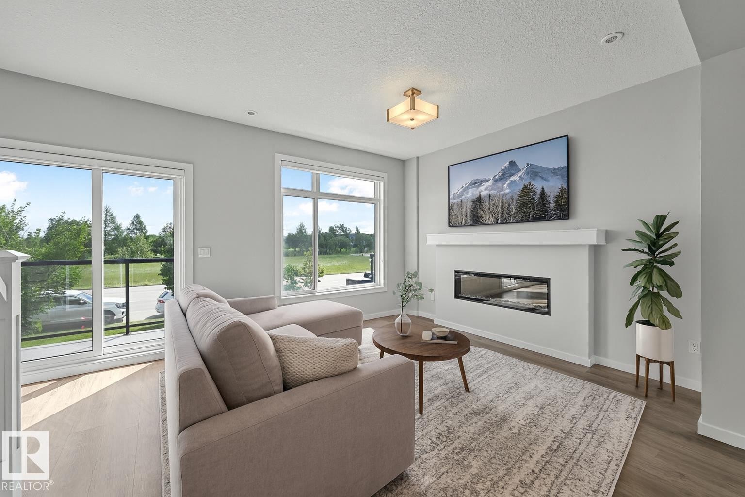 virtually staged - #72 1010 Rabbit Hill Rd Sw, Edmonton, AB - Indoor Photo Showing Living Room With Fireplace