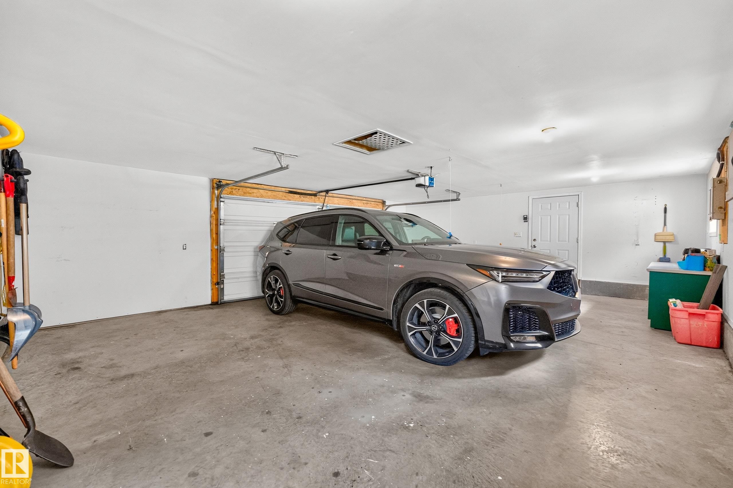 Triple w/ double size door - 6716 101A Avenue Nw, Edmonton, AB - Indoor Photo Showing Garage