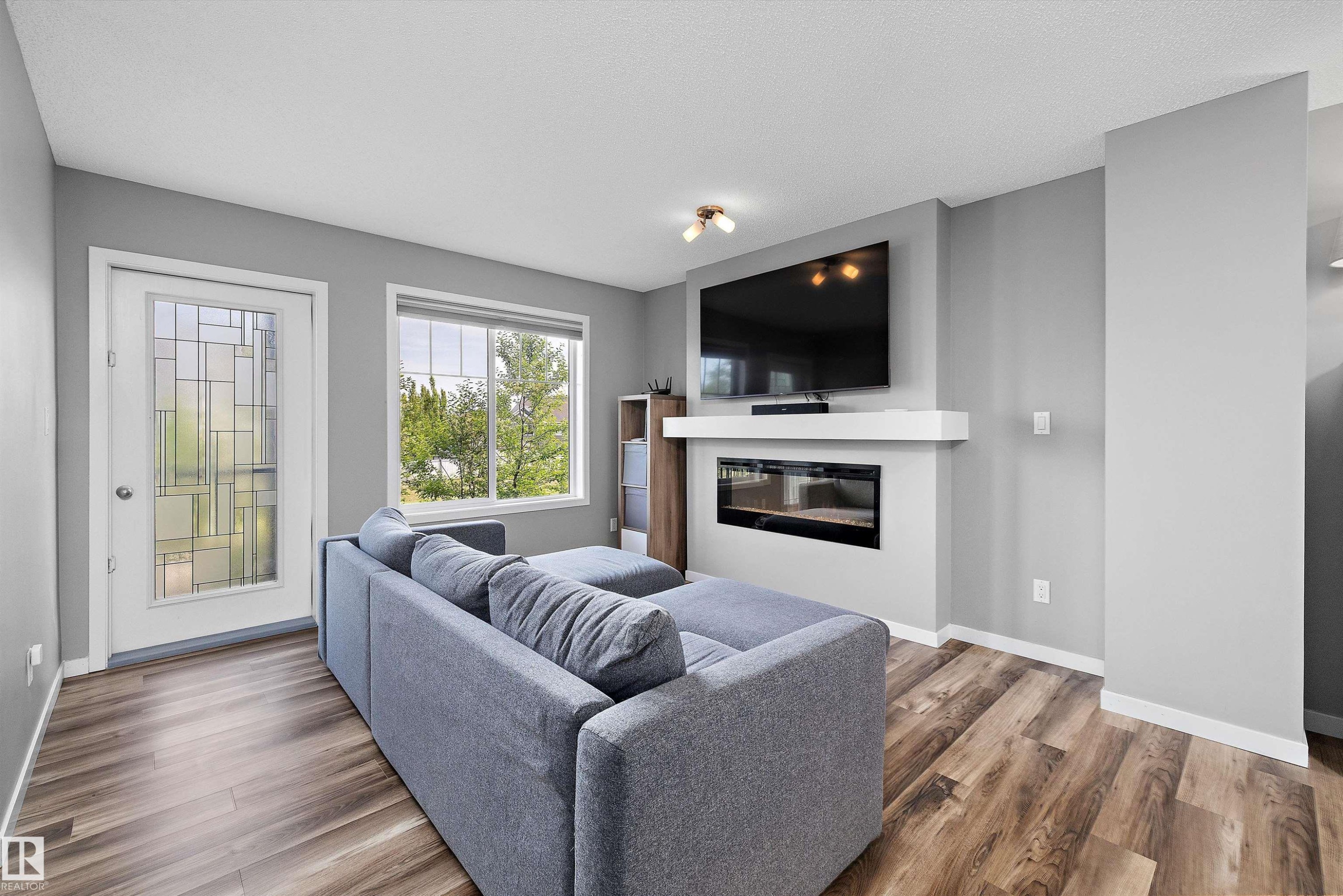 128 3305 Orchards Link, Edmonton, AB - Indoor Photo Showing Living Room With Fireplace