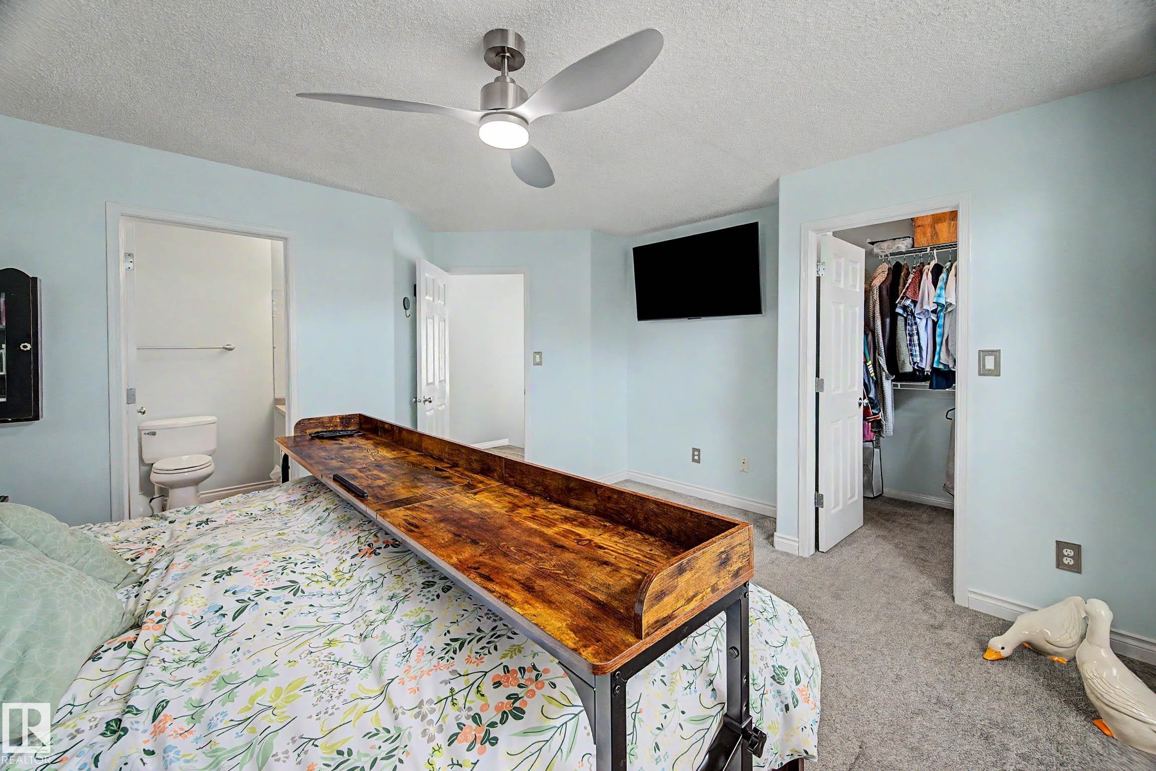 Bedroom featuring light blue walls and neutral carpeting - 9130 100A Avenue Nw, Edmonton, AB - Indoor Photo Showing Bedroom