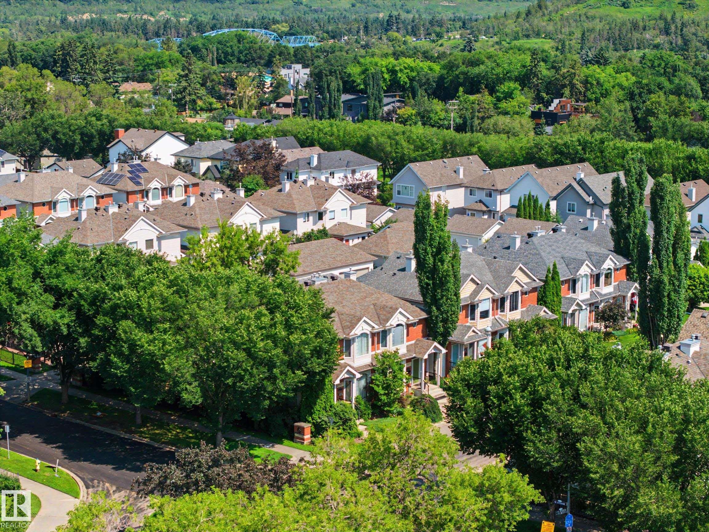 Residential area featuring mature trees and a mix of detached homes and townhouses - 9130 100A Avenue Nw, Edmonton, AB - Outdoor