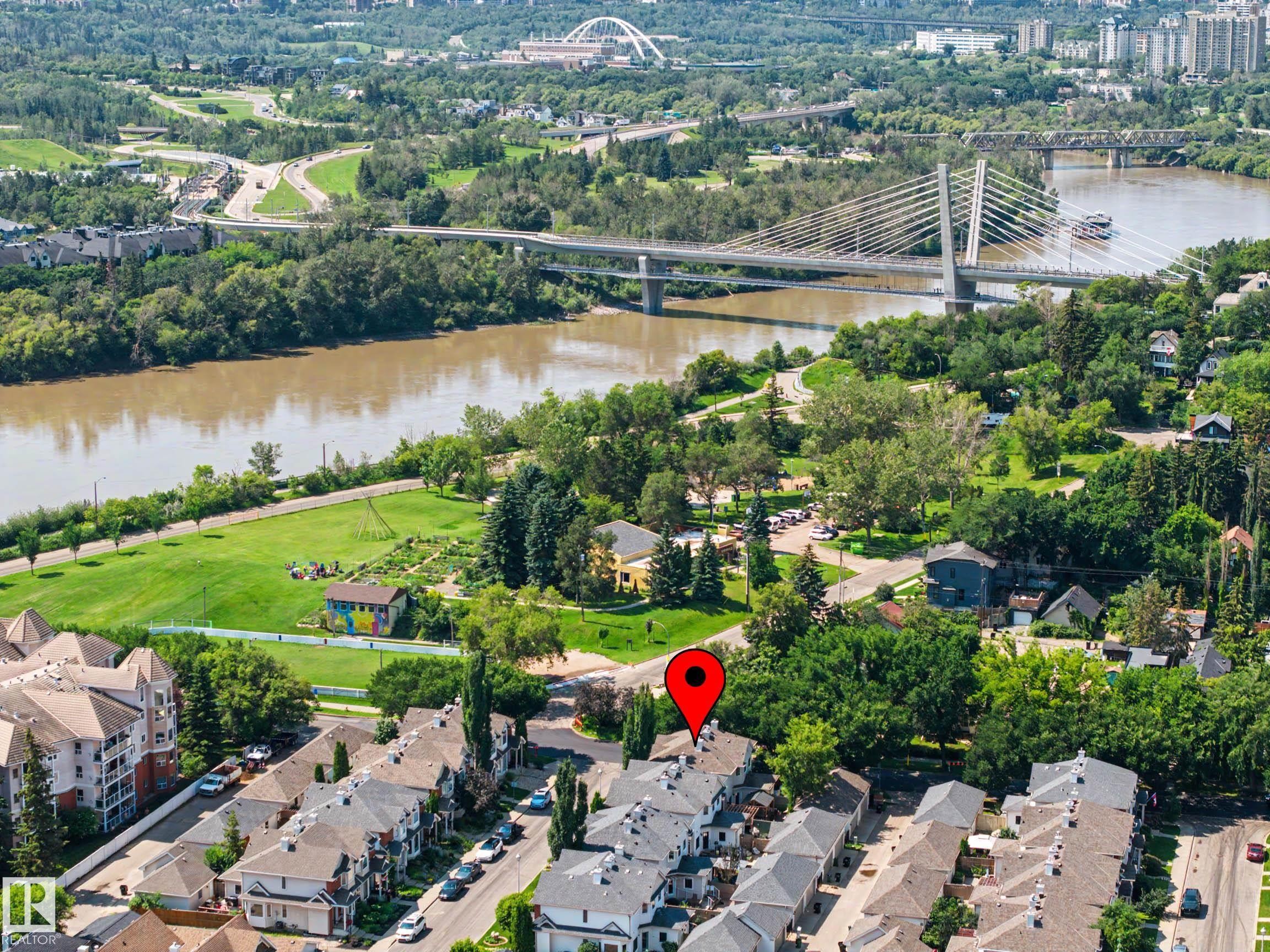 Aerial perspective highlighting urban density and proximity to riverfront greenspace - 9130 100A Avenue Nw, Edmonton, AB - Outdoor With Body Of Water With View