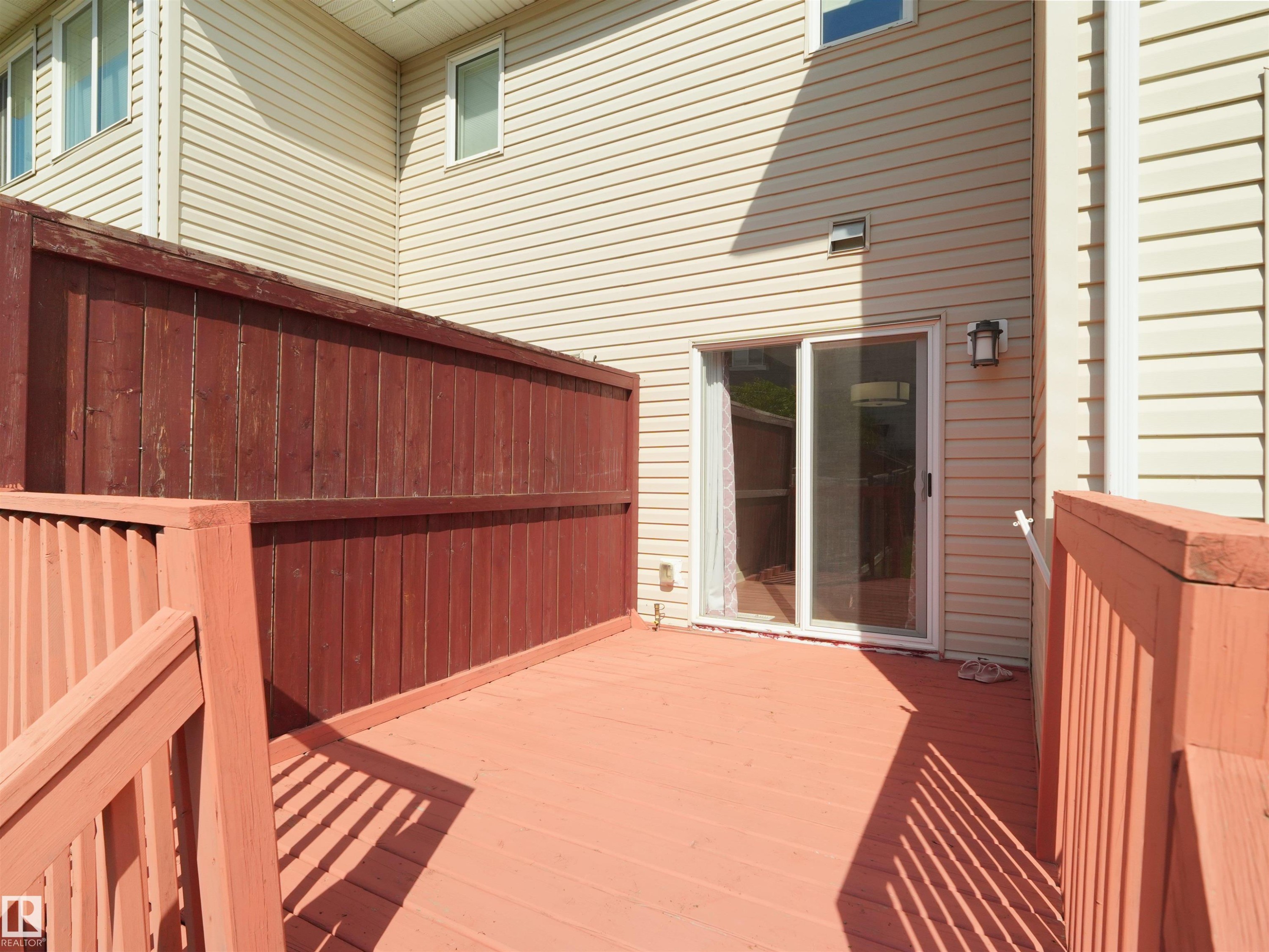 Private outdoor deck with painted wood flooring and matching railings - 4487 Annett Common Sw, Edmonton, AB - Outdoor With Exterior