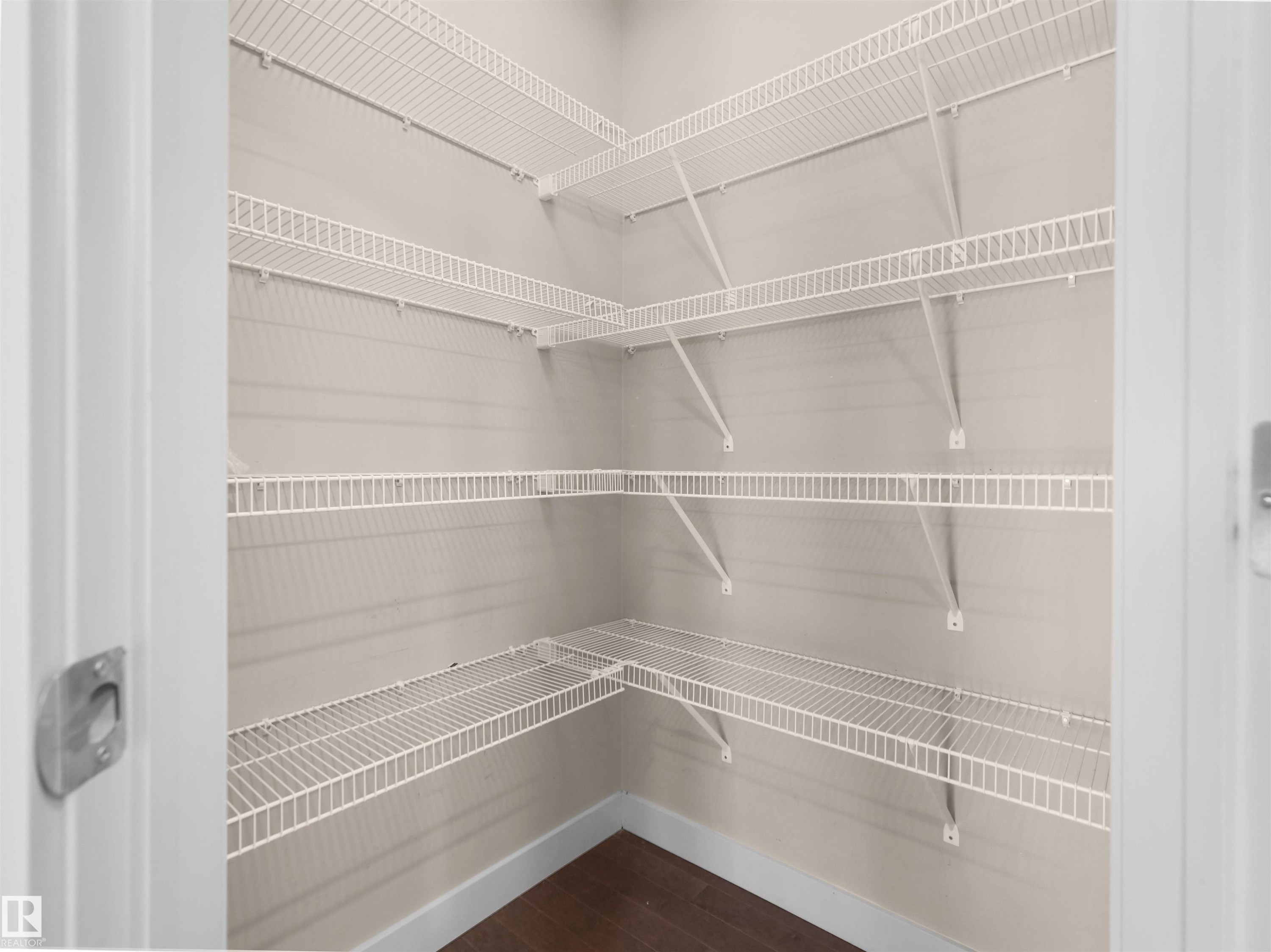 White wire shelving system providing multiple levels of storage - 4487 Annett Common Sw, Edmonton, AB - Indoor With Storage