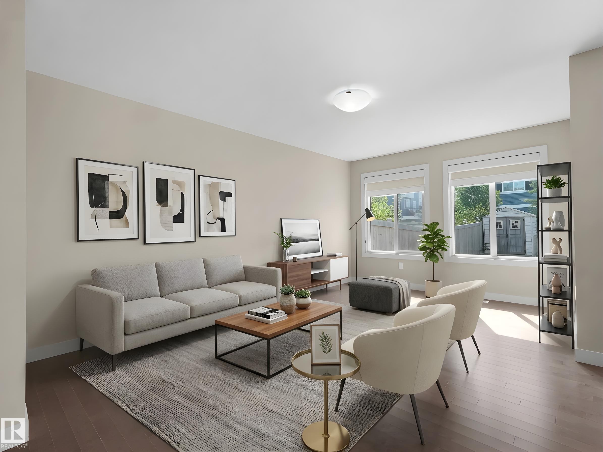 Spacious living area featuring light-toned walls, recessed lighting, and wood-finish flooring - 4487 Annett Common Sw, Edmonton, AB - Indoor Photo Showing Living Room