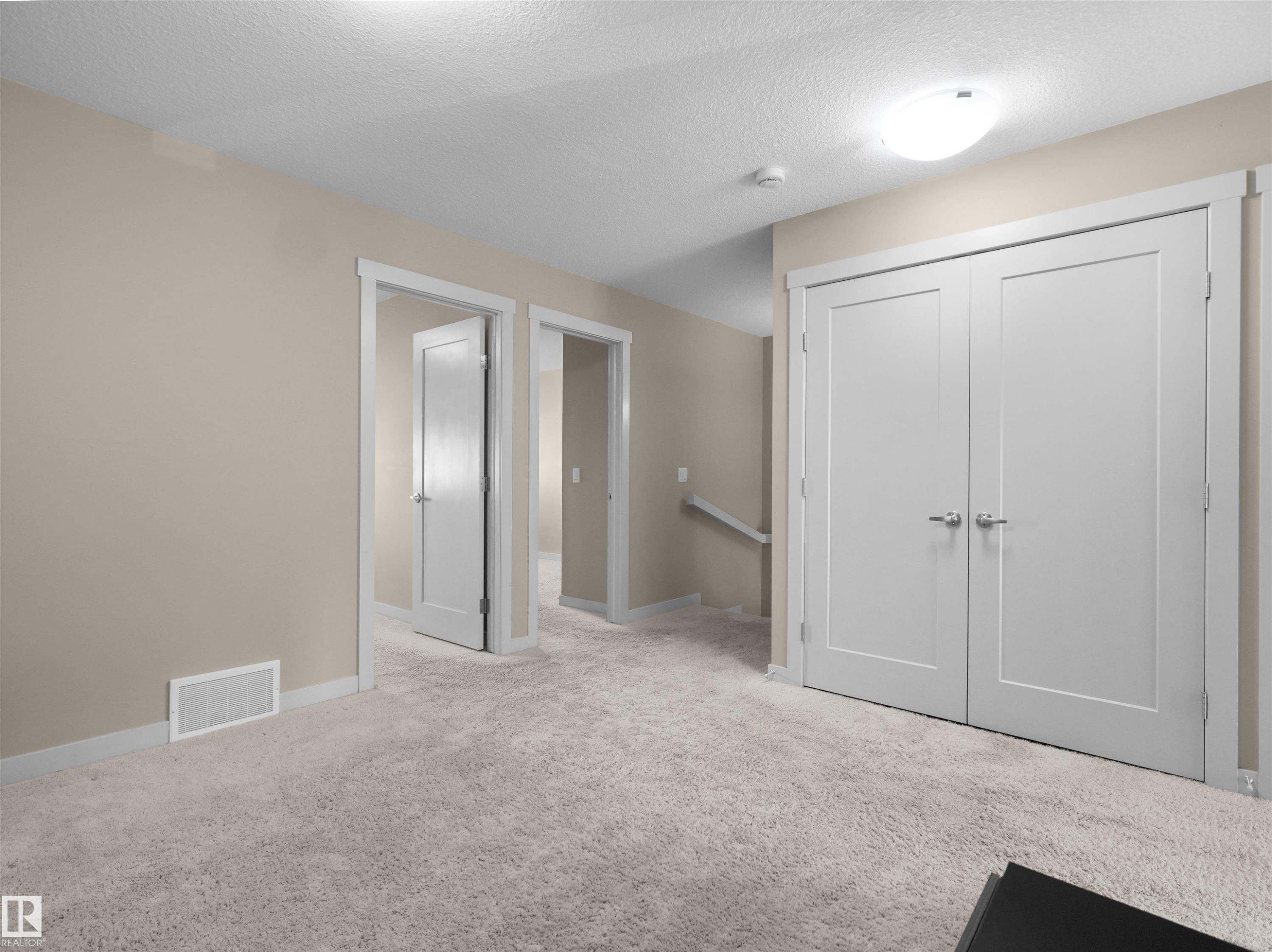 Plush light-toned carpeting spanning the floor - 4487 Annett Common Sw, Edmonton, AB - Indoor Photo Showing Other Room