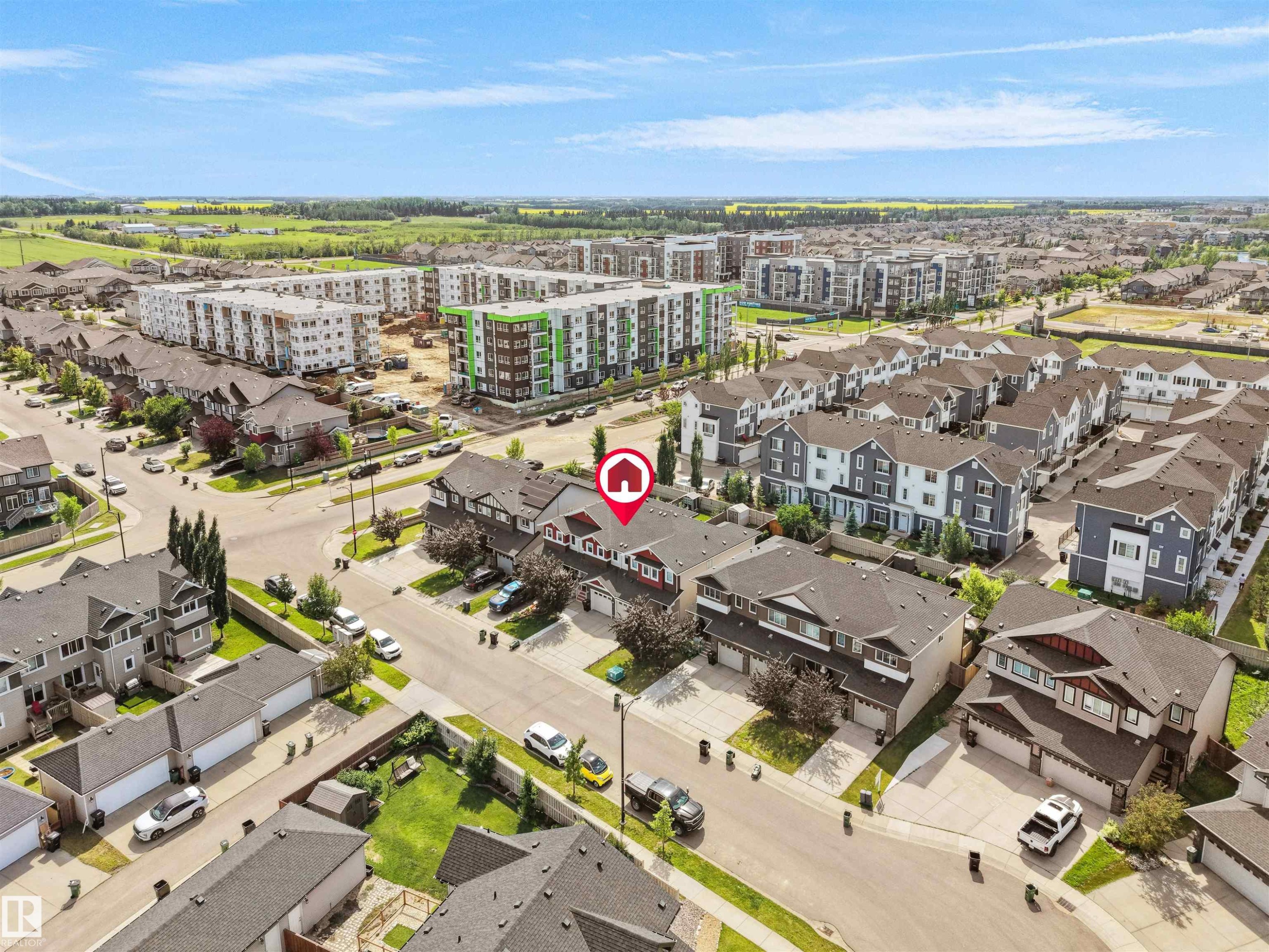 Aerial perspective showcasing a residential neighborhood with a mix of townhomes and detached houses - 4487 Annett Common Sw, Edmonton, AB - Outdoor With View