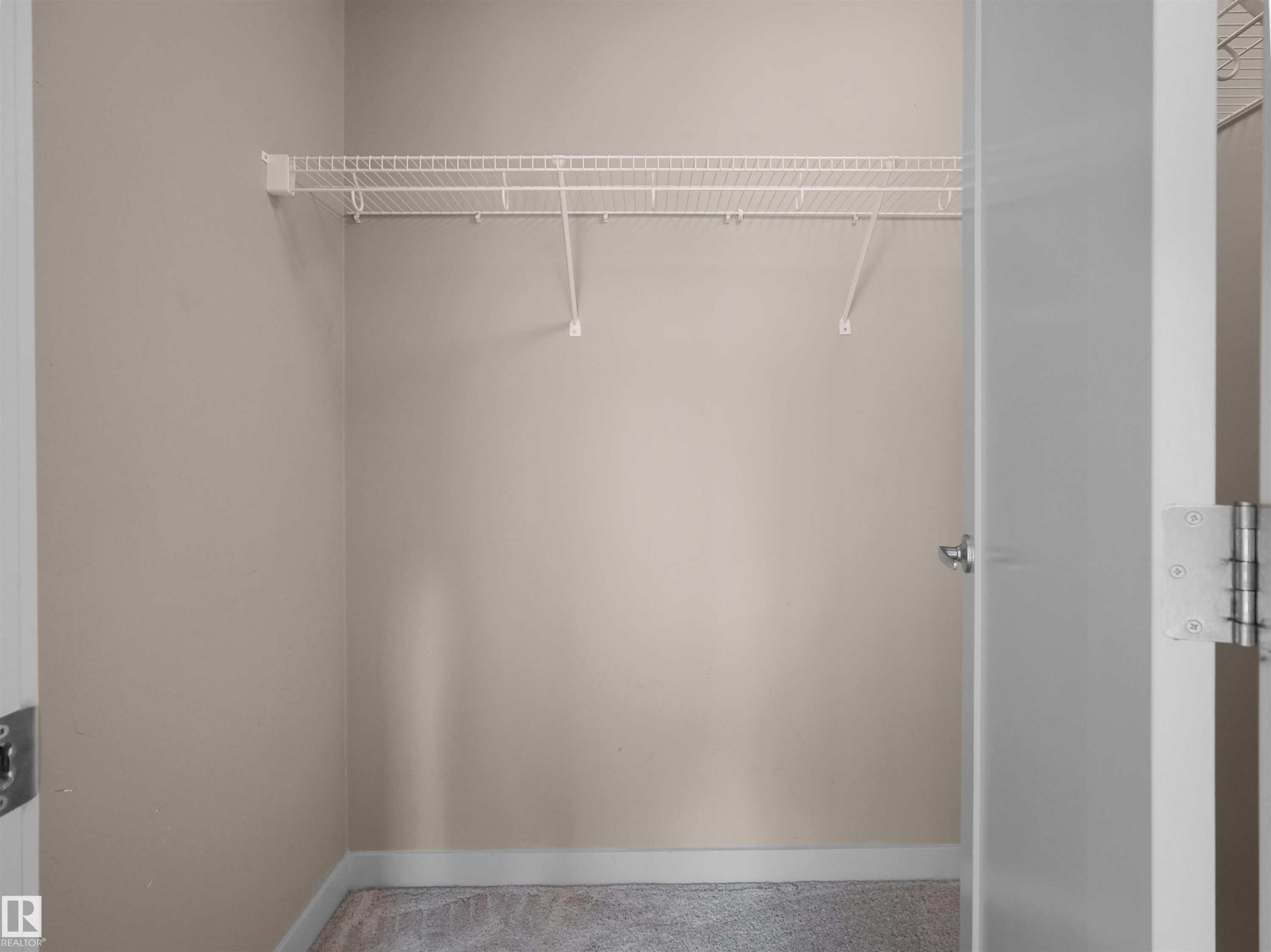 Closet space featuring neutral wall paint, white trim, and a white wire shelving system - 4487 Annett Common Sw, Edmonton, AB - Indoor With Storage
